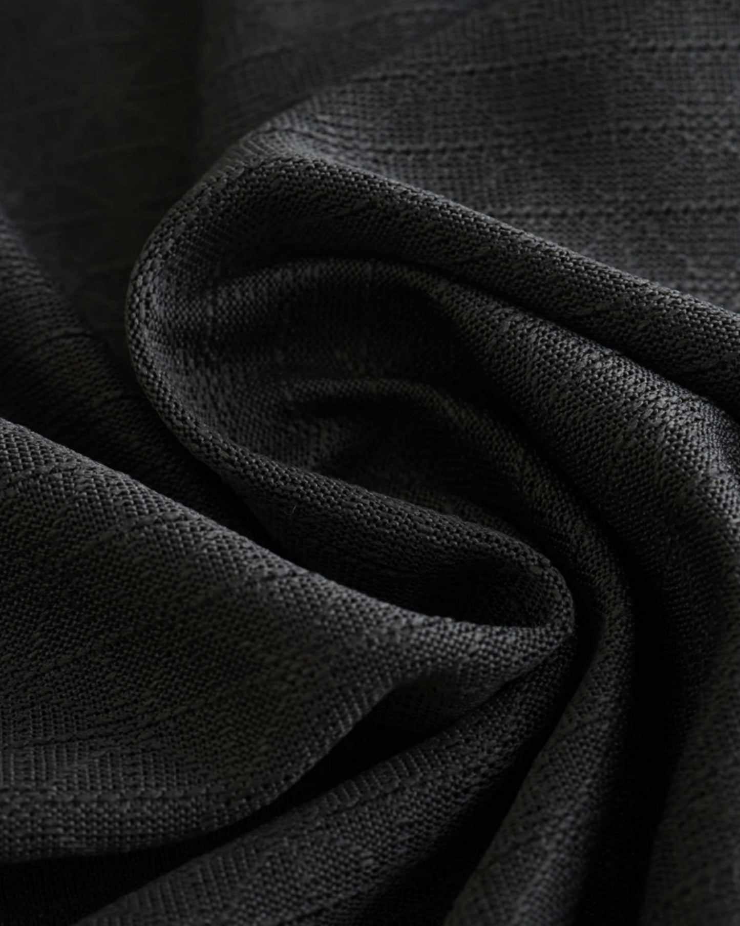 Close-up of AC Milan third football jersey 2024/25 charcoal fabric with woven texture
