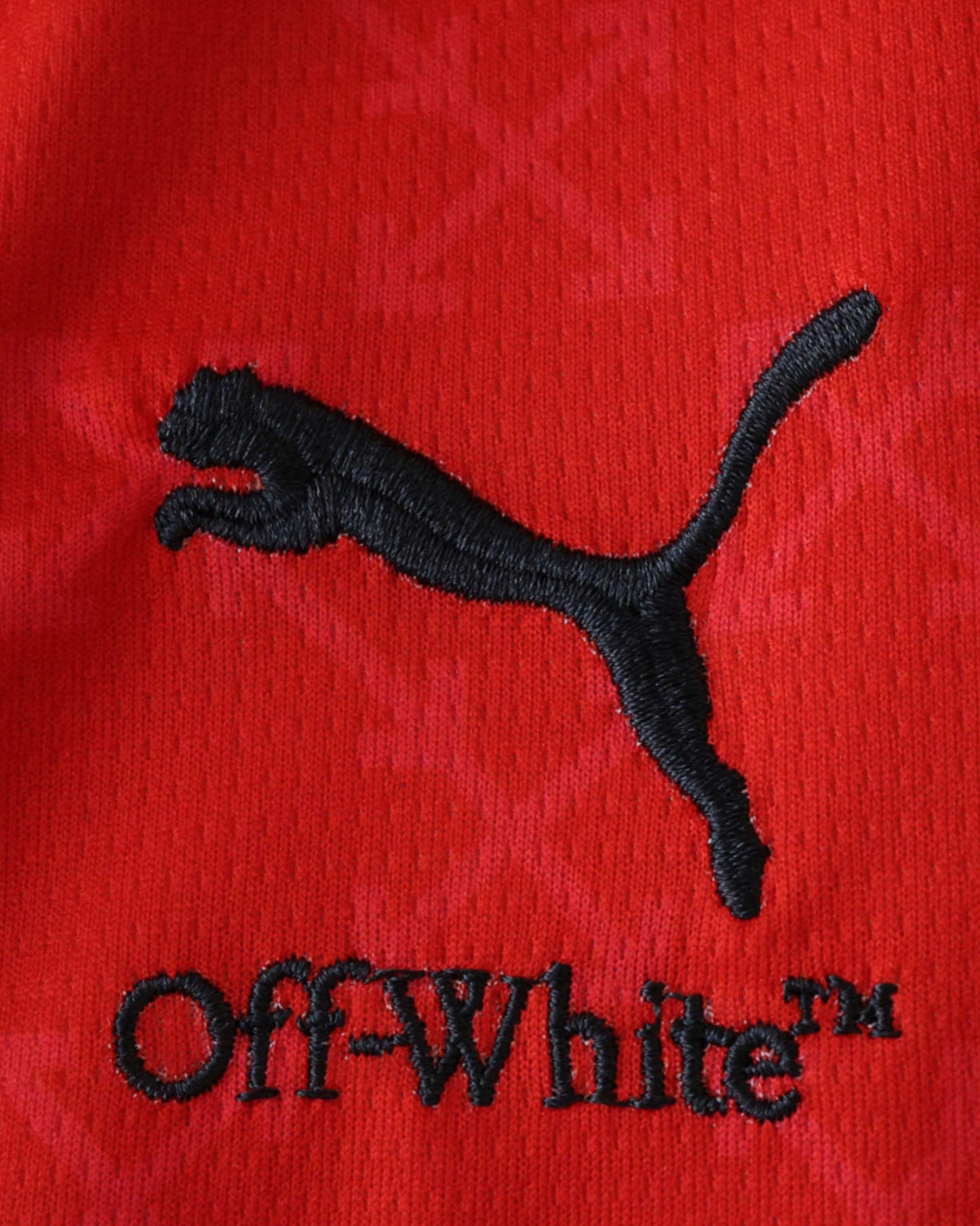 AC Milan x Off-White football jersey detail of Puma logo, DIAVOLI badge and Off-White text