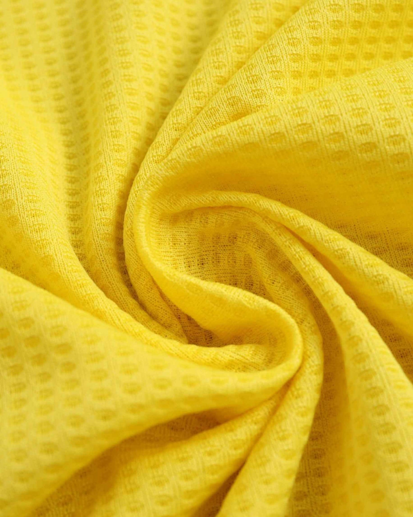 Close-up of yellow waffle-knit breathable fabric on the Al Nassr 2024/25 home football jersey