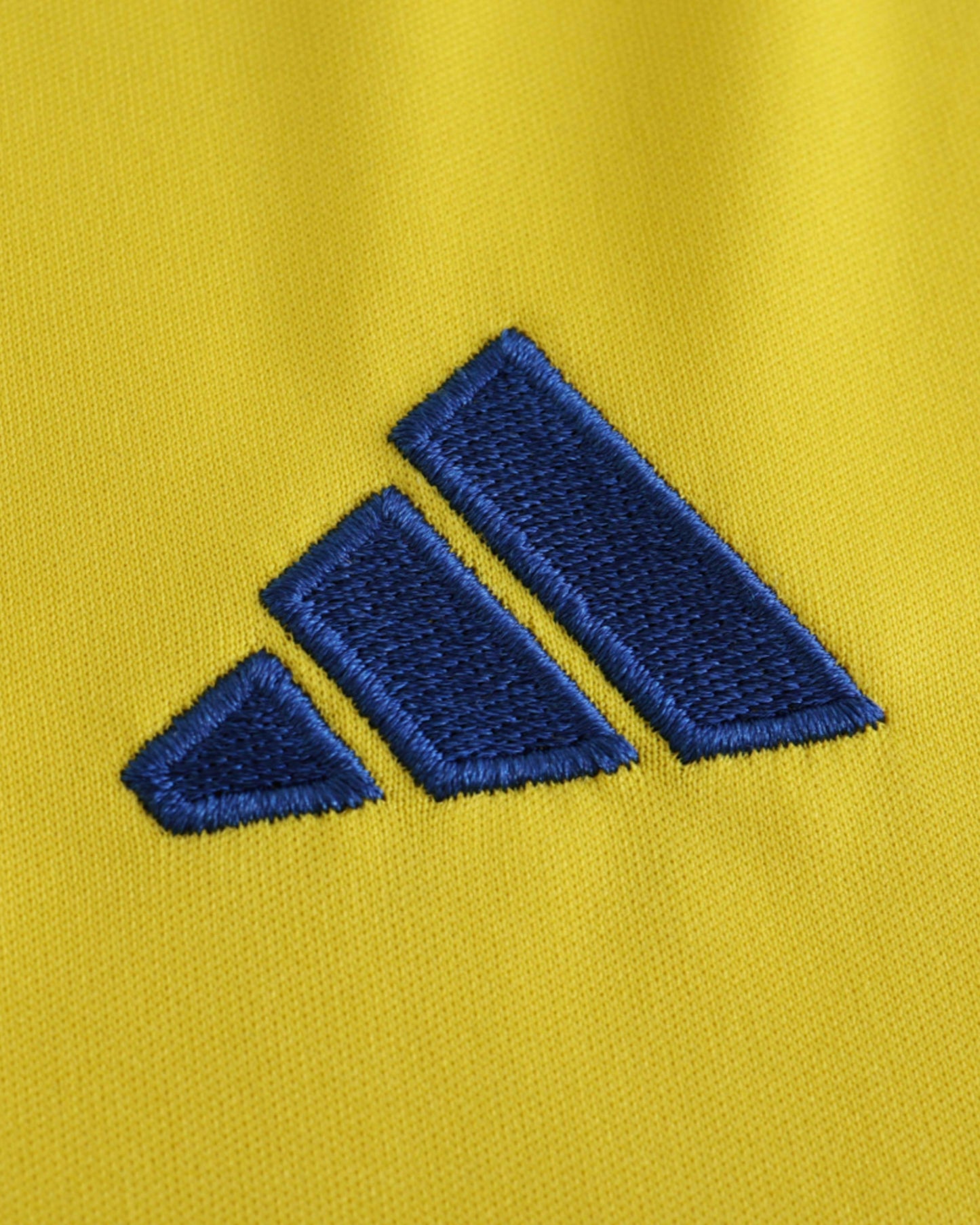 Al Nassr home kids football jersey 2024/25 detail of blue Adidas logo on yellow shirt