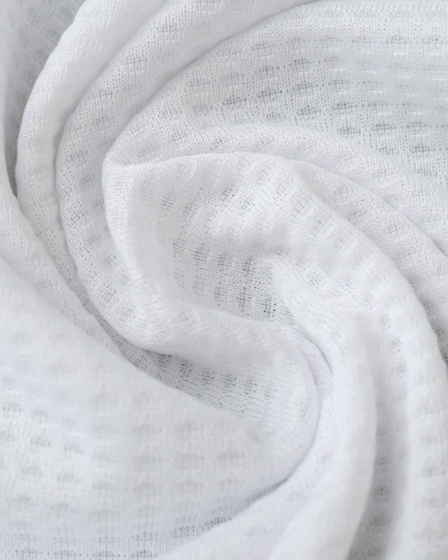 White textured fabric with a subtle pattern.