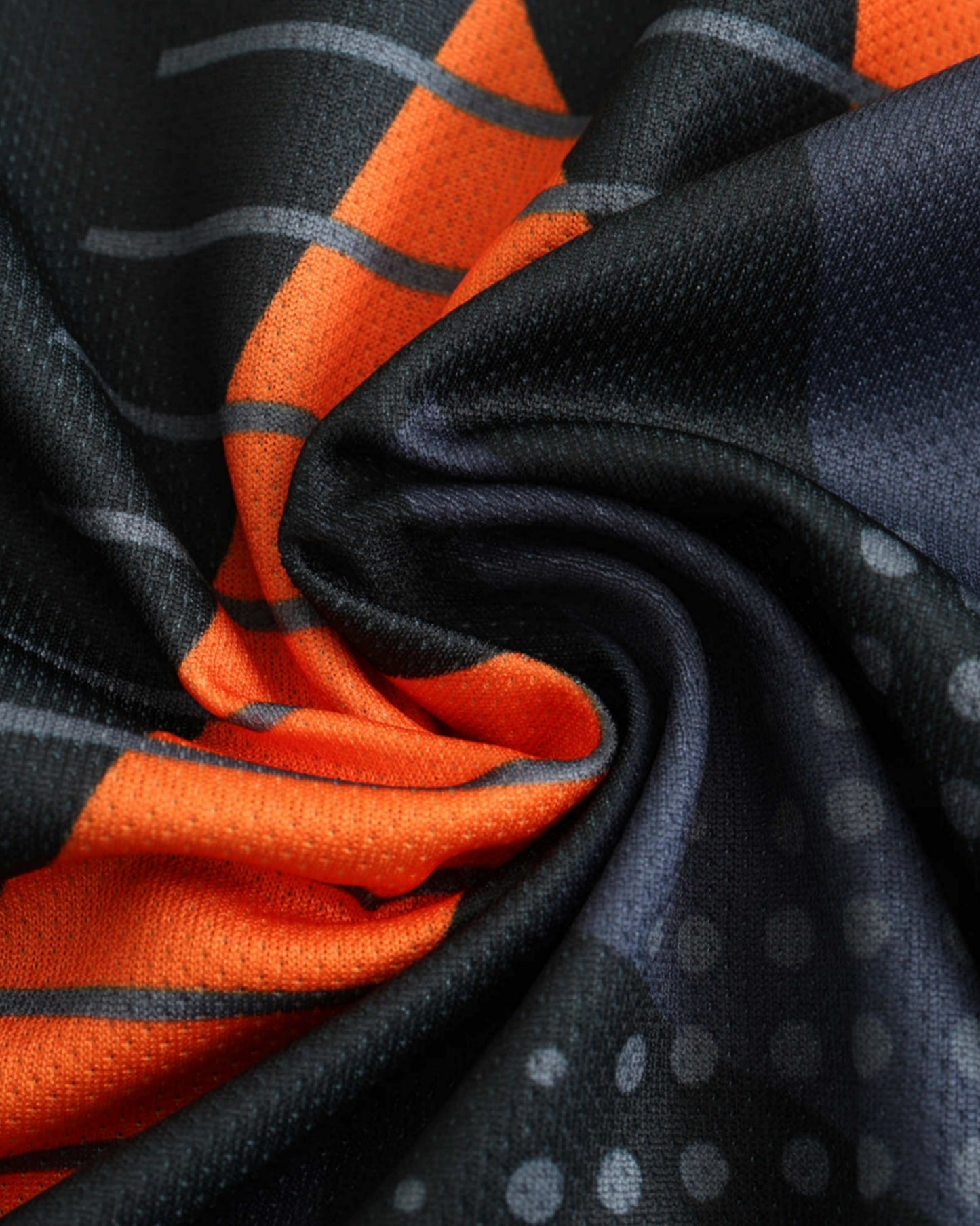 Close-up of black and orange Argentina 2024/25 goalkeeper football jersey geometric camo pattern