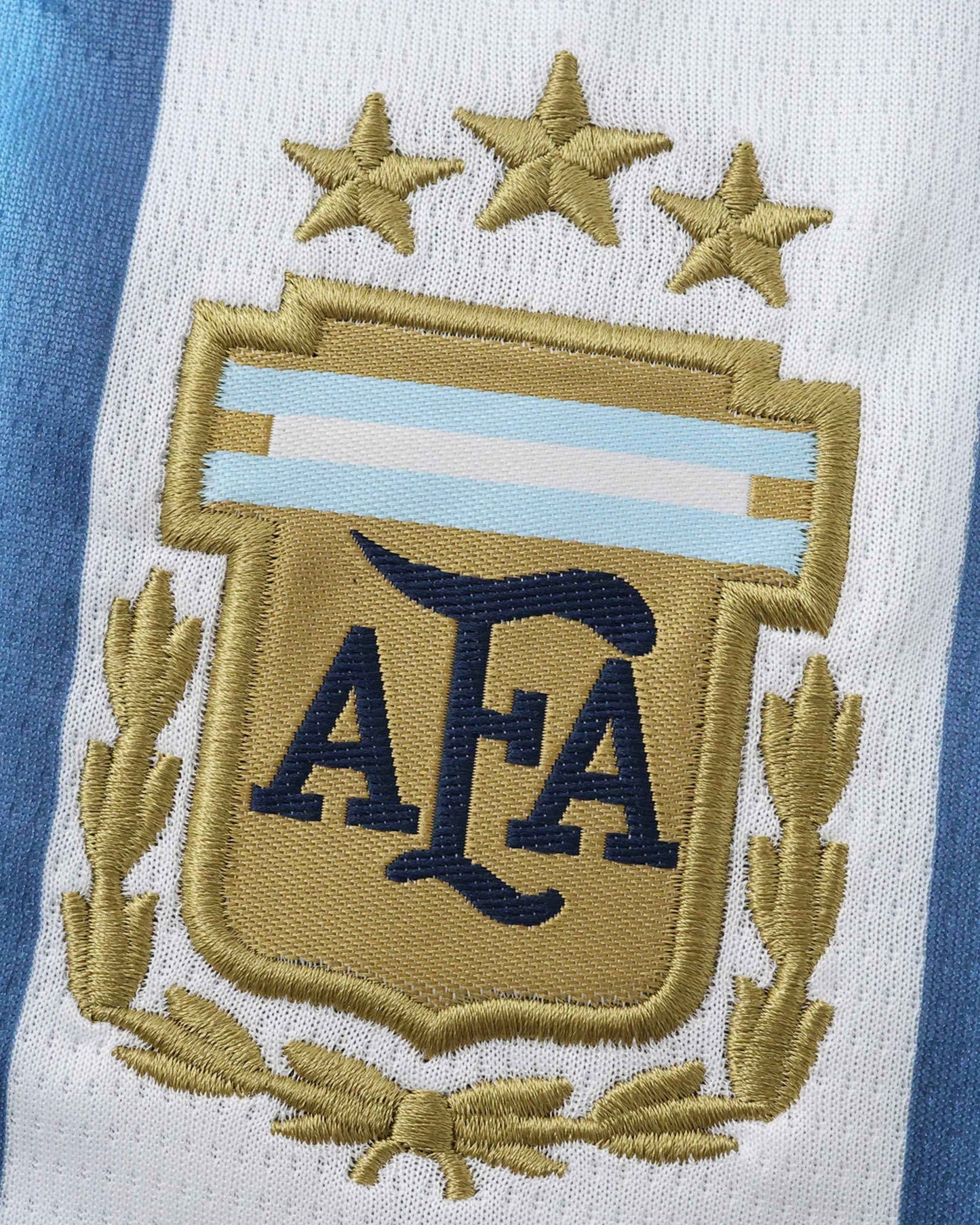 Back of Argentina home 2026 World Cup kids football kit with navy striped shorts