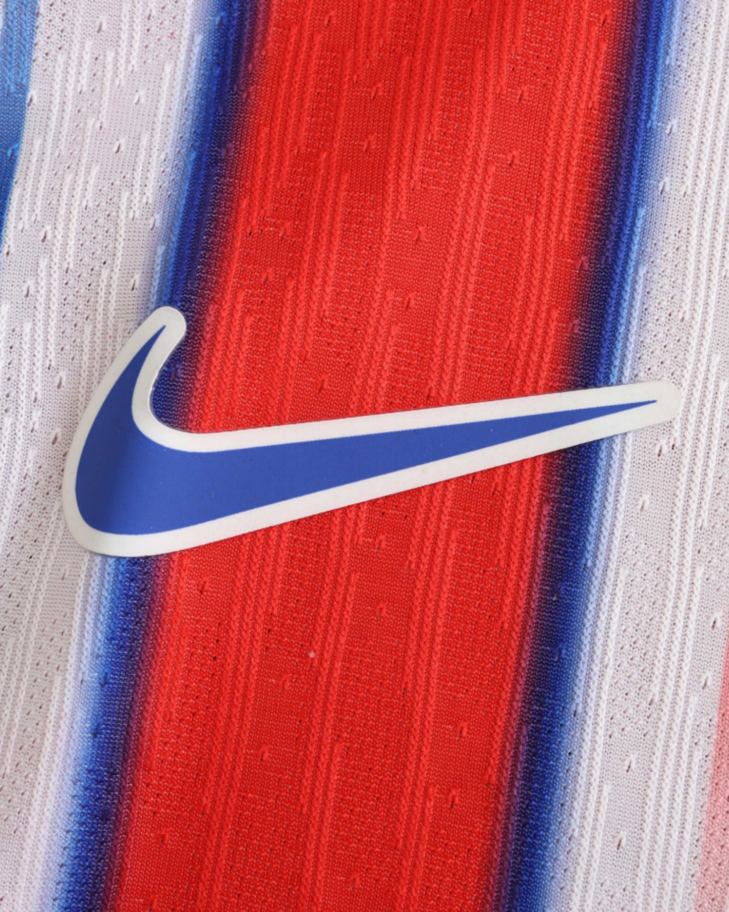 Atletico Madrid home football jersey 2024/25 with white Nike swoosh on striped fabric