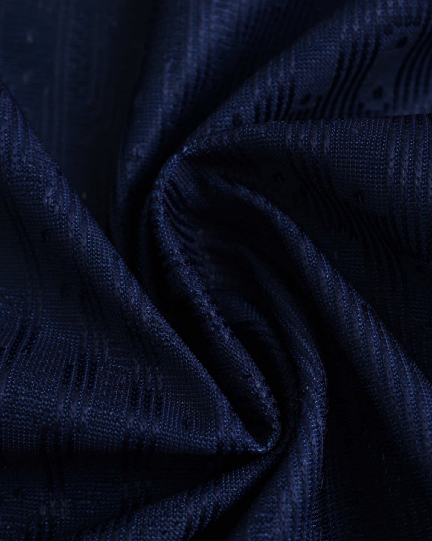 Atletico Madrid third football jersey 2024/25 close-up of navy textured fabric