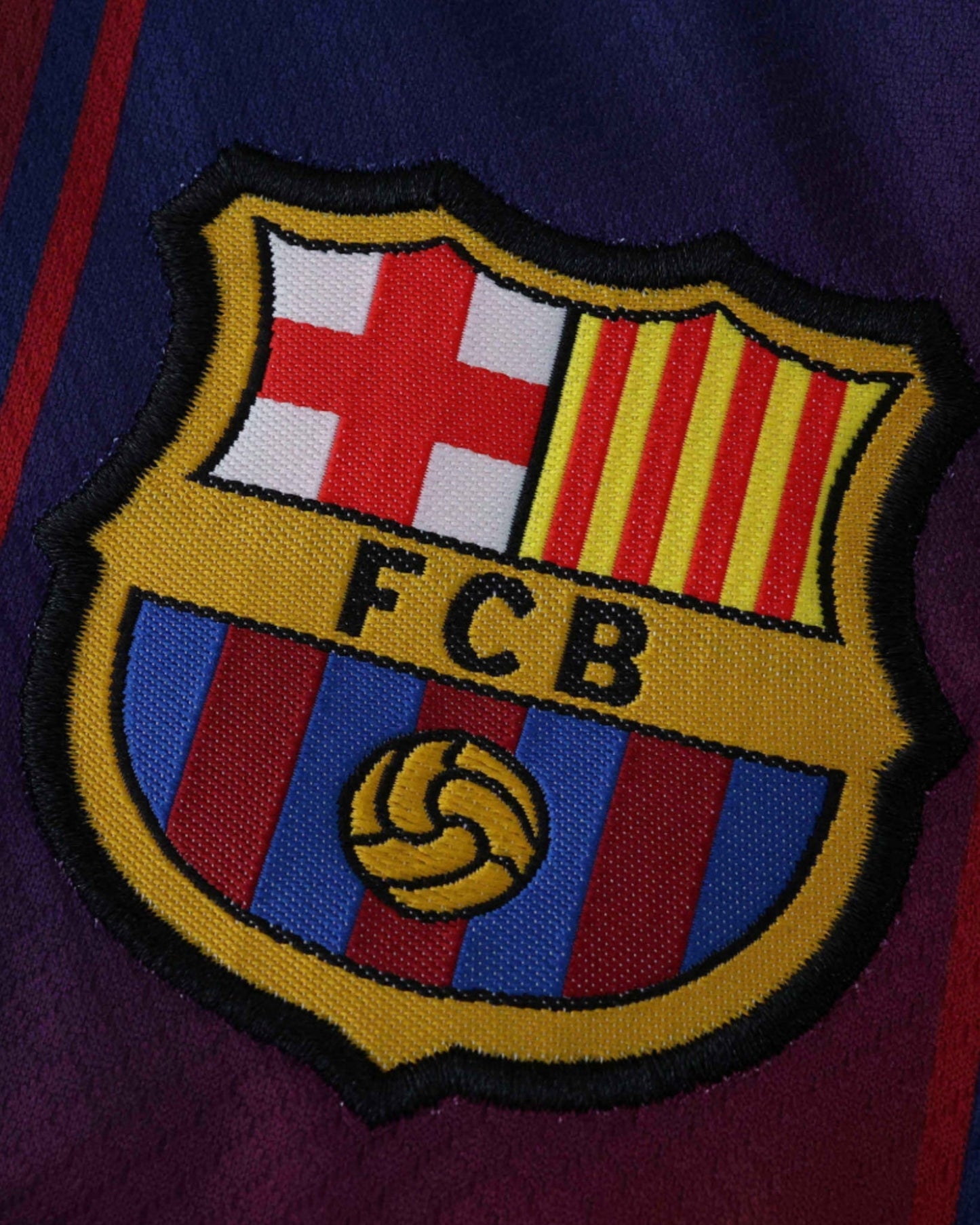 Barcelona home kids football jersey 2025/26 close-up of FC Barcelona crest on blue and red stripes