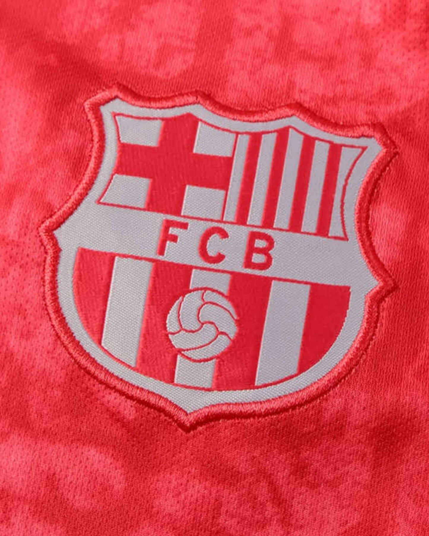 A close-up of the FCB logo on a red jersey.