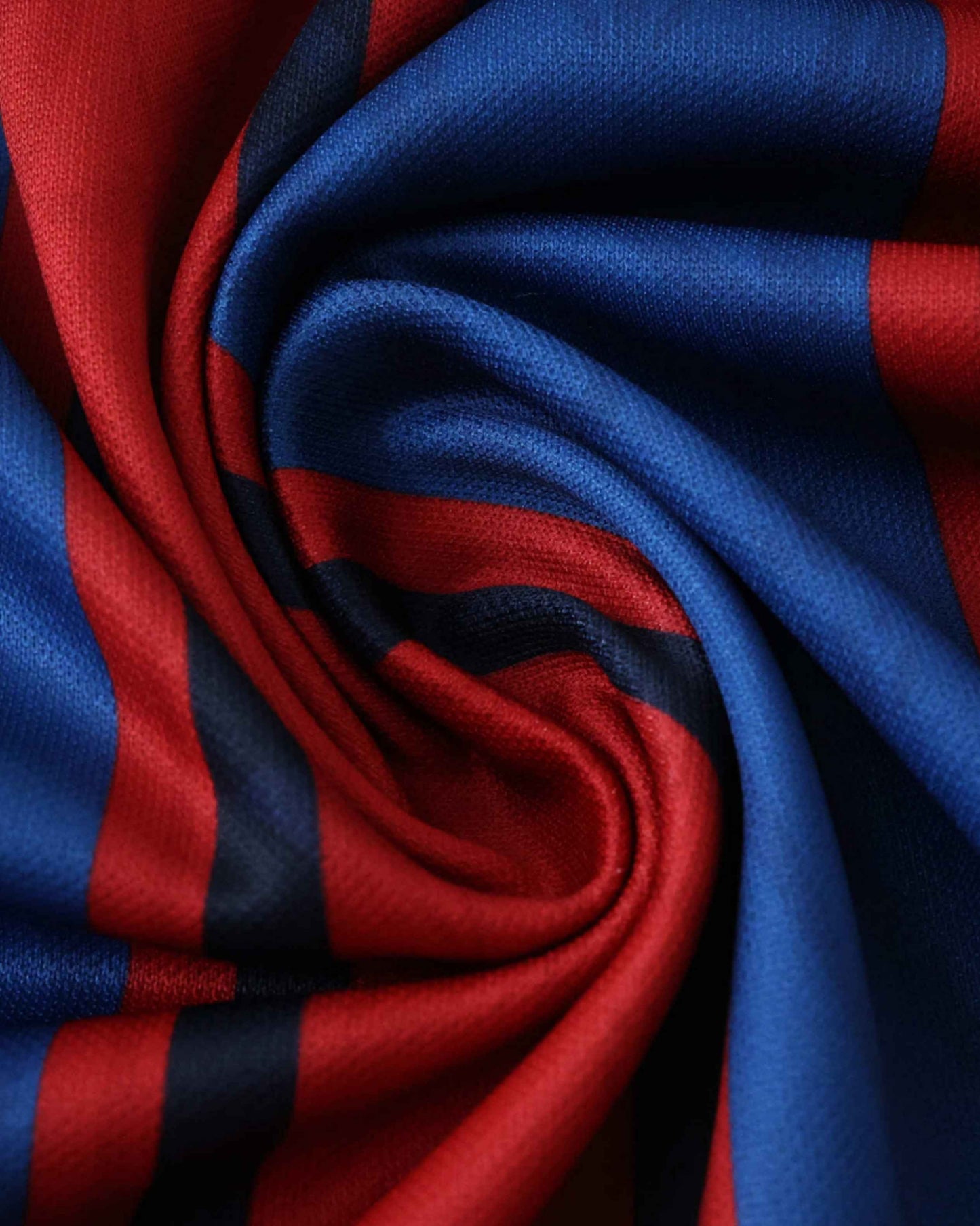 A close-up of red and blue striped fabric with a textured weave.