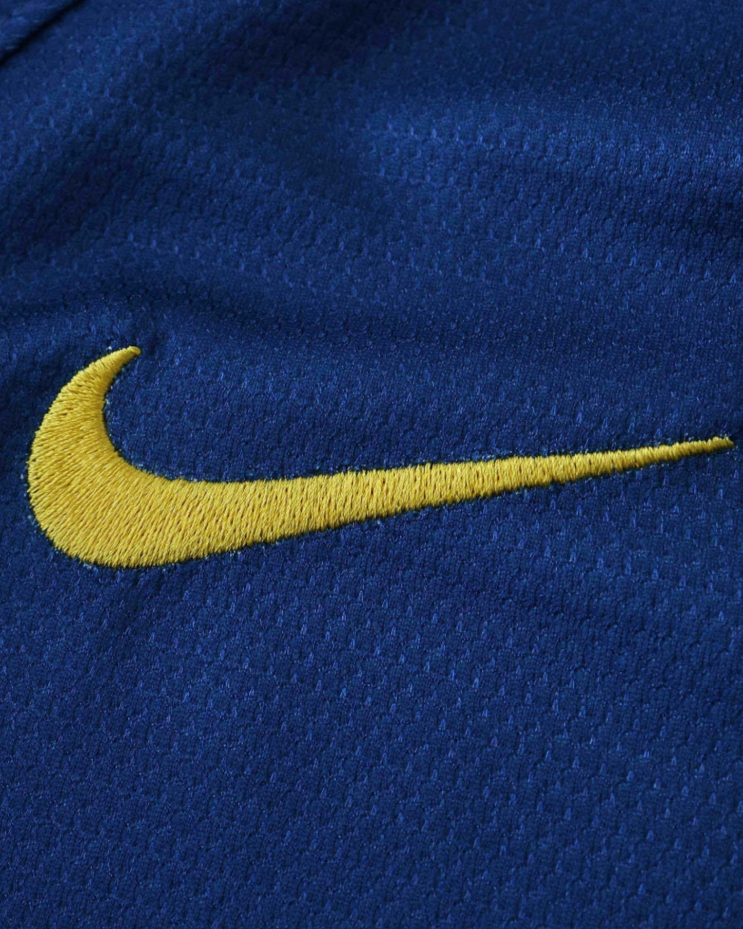 Gold Nike swoosh on blue fabric of Barcelona 2008/09 retro home kids football jersey