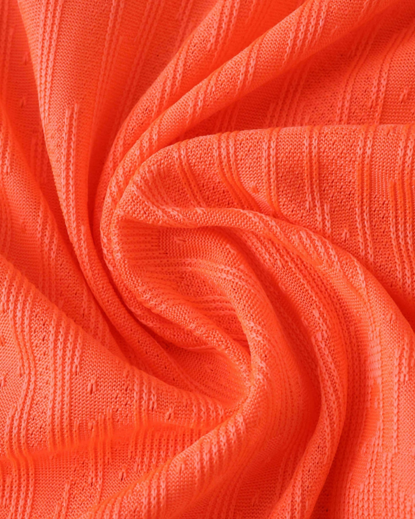Coral-orange ribbed fabric texture of the Barcelona third football jersey 2025/26