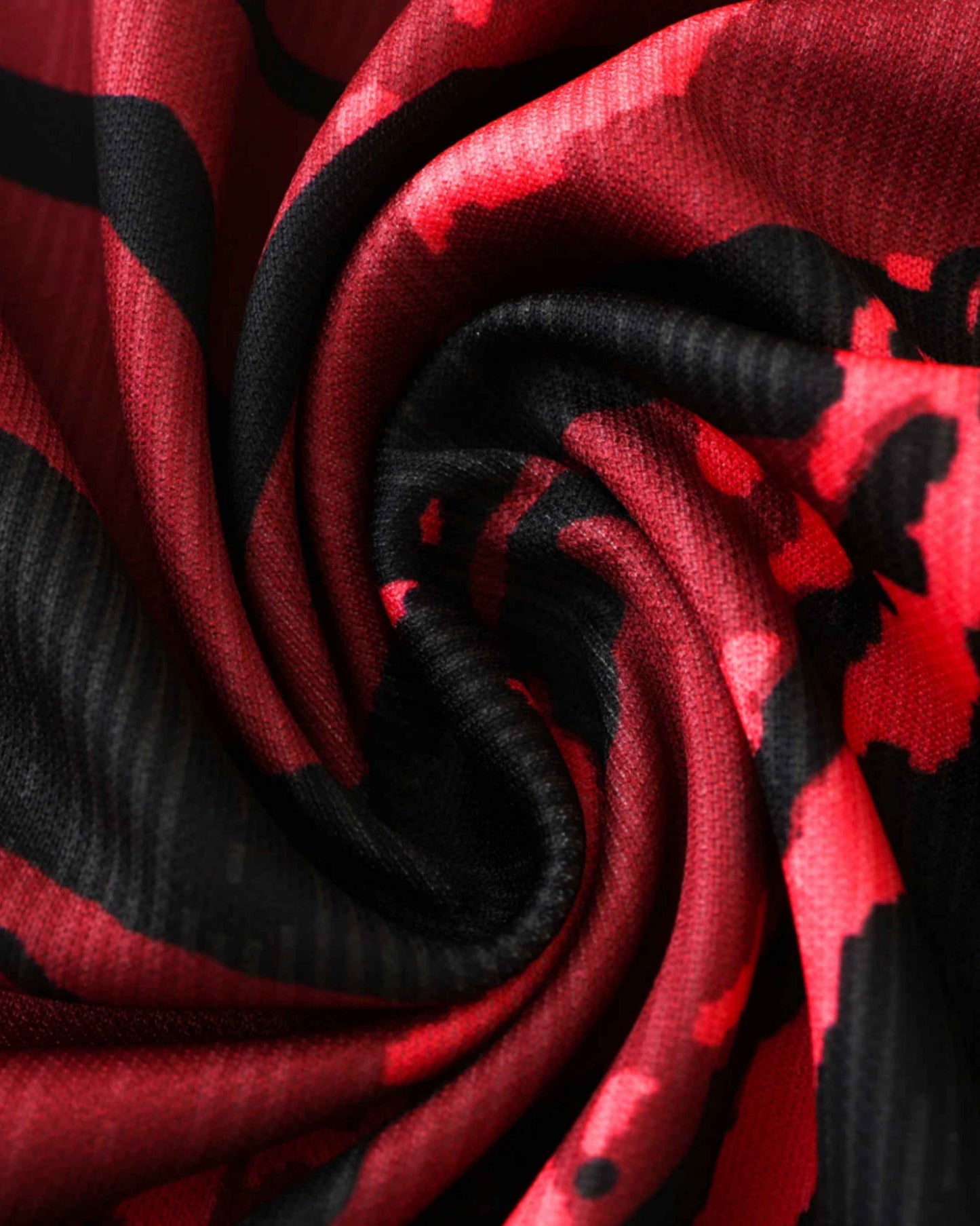 Red and black patterned fabric with a textured weave.
