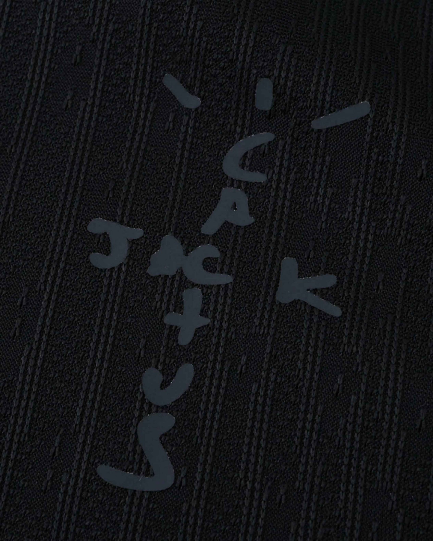 Black fabric with a textured pattern and a grey cactus jack logo.
