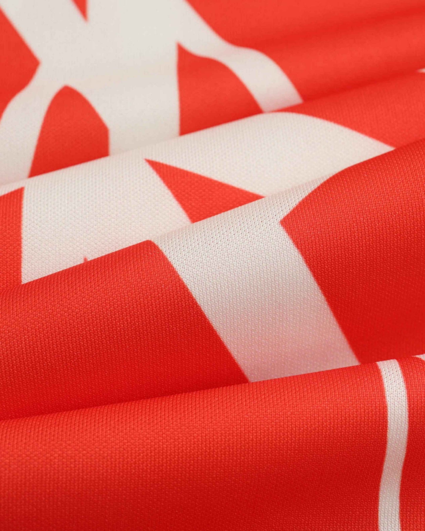 Red and white striped fabric of a football training jersey.