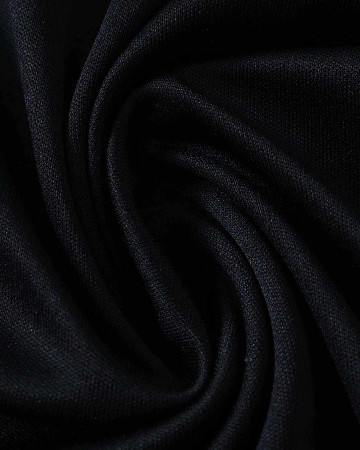 Black fabric with a subtle knit texture, draped in soft folds.