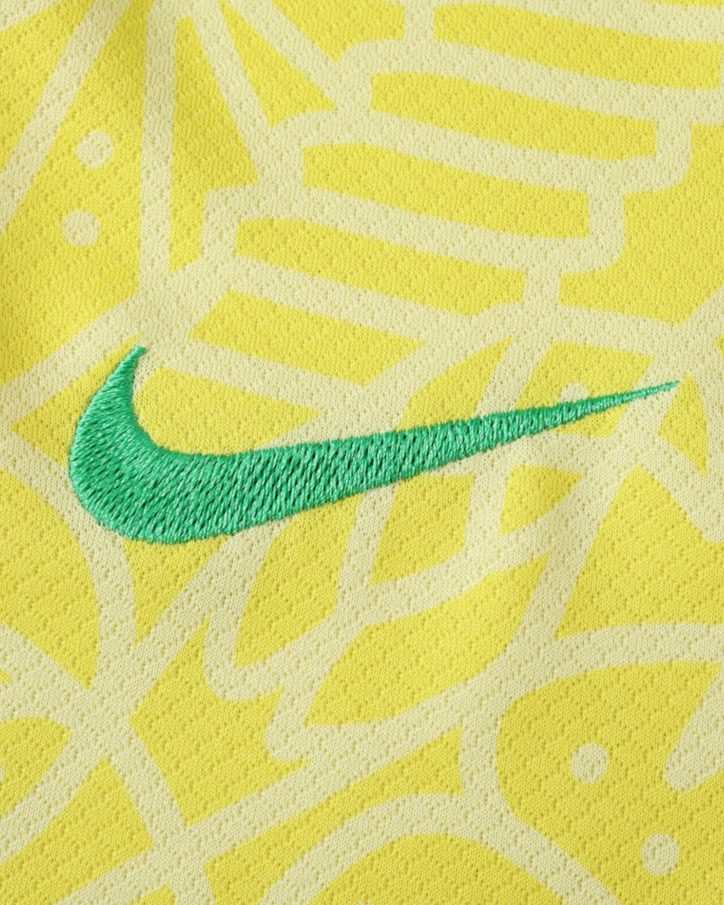 Brazil home kids football jersey 2024/25 detail of green Nike swoosh on tonal map-print fabric