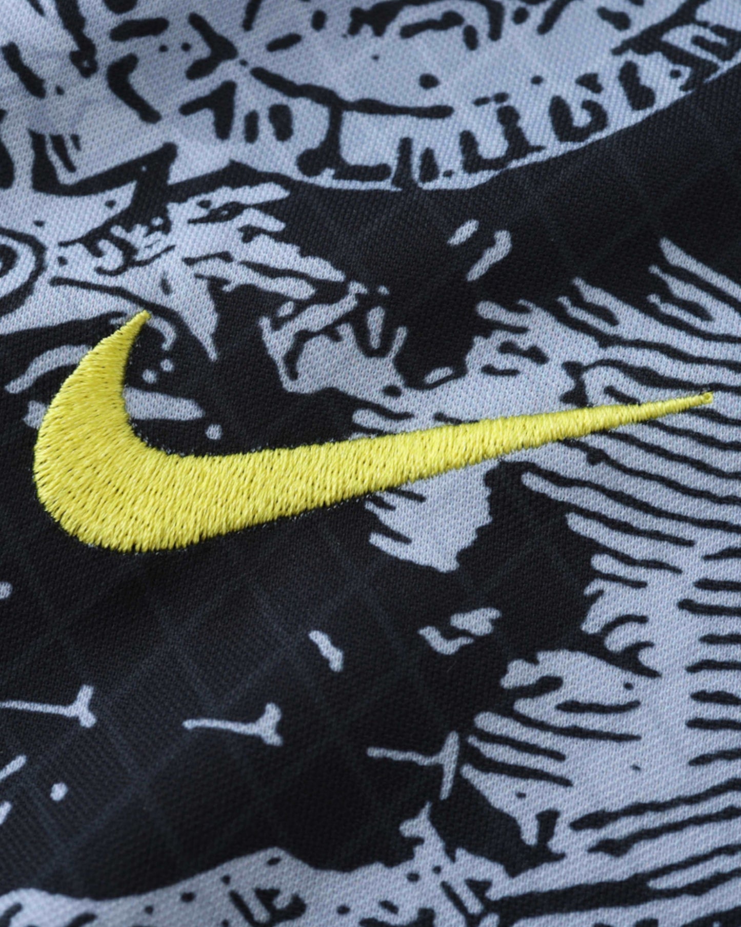 Yellow Nike swoosh on black and white patterned Brazil x Jesus kids football jersey