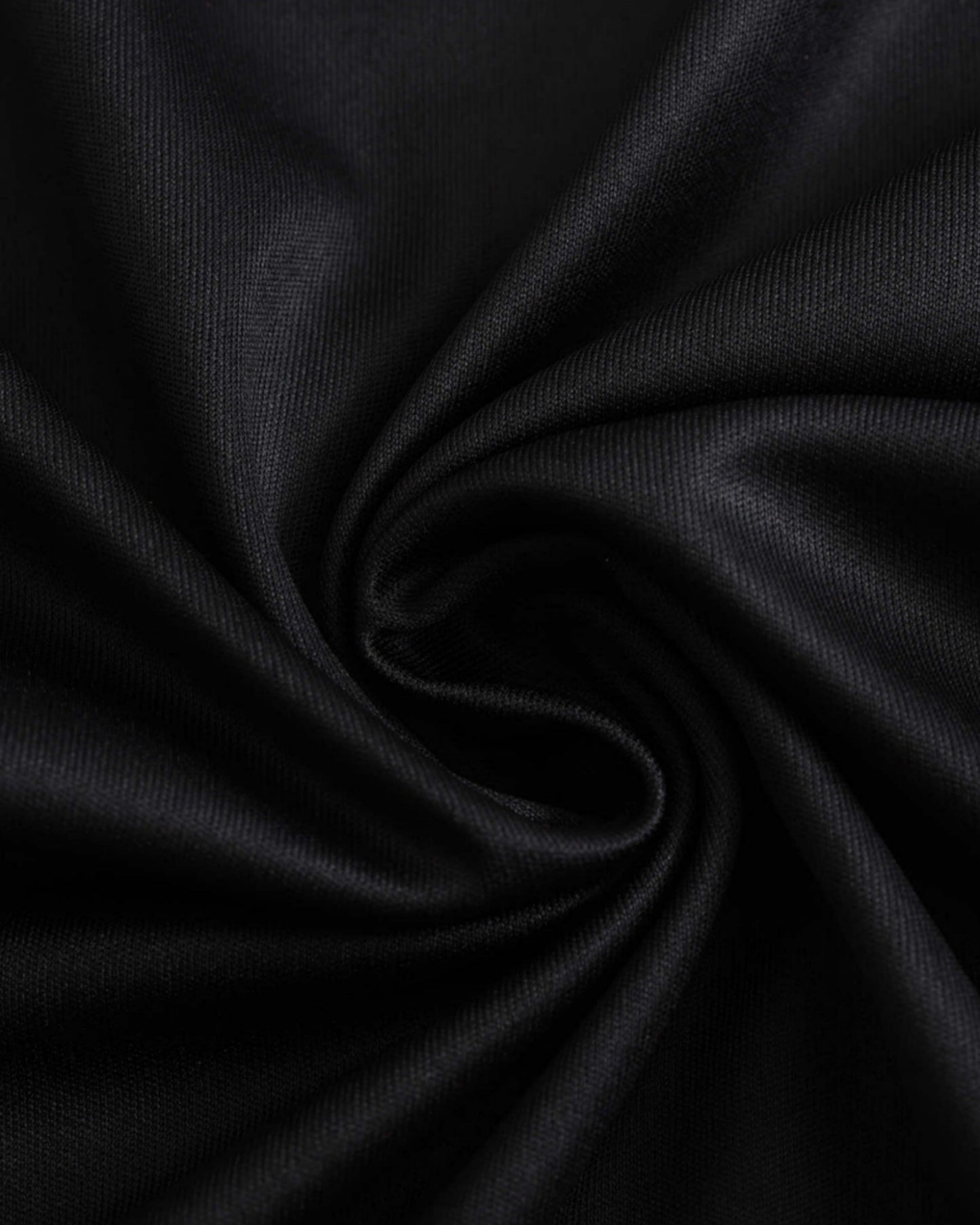 Black fabric with a subtle texture, likely a soccer jersey.