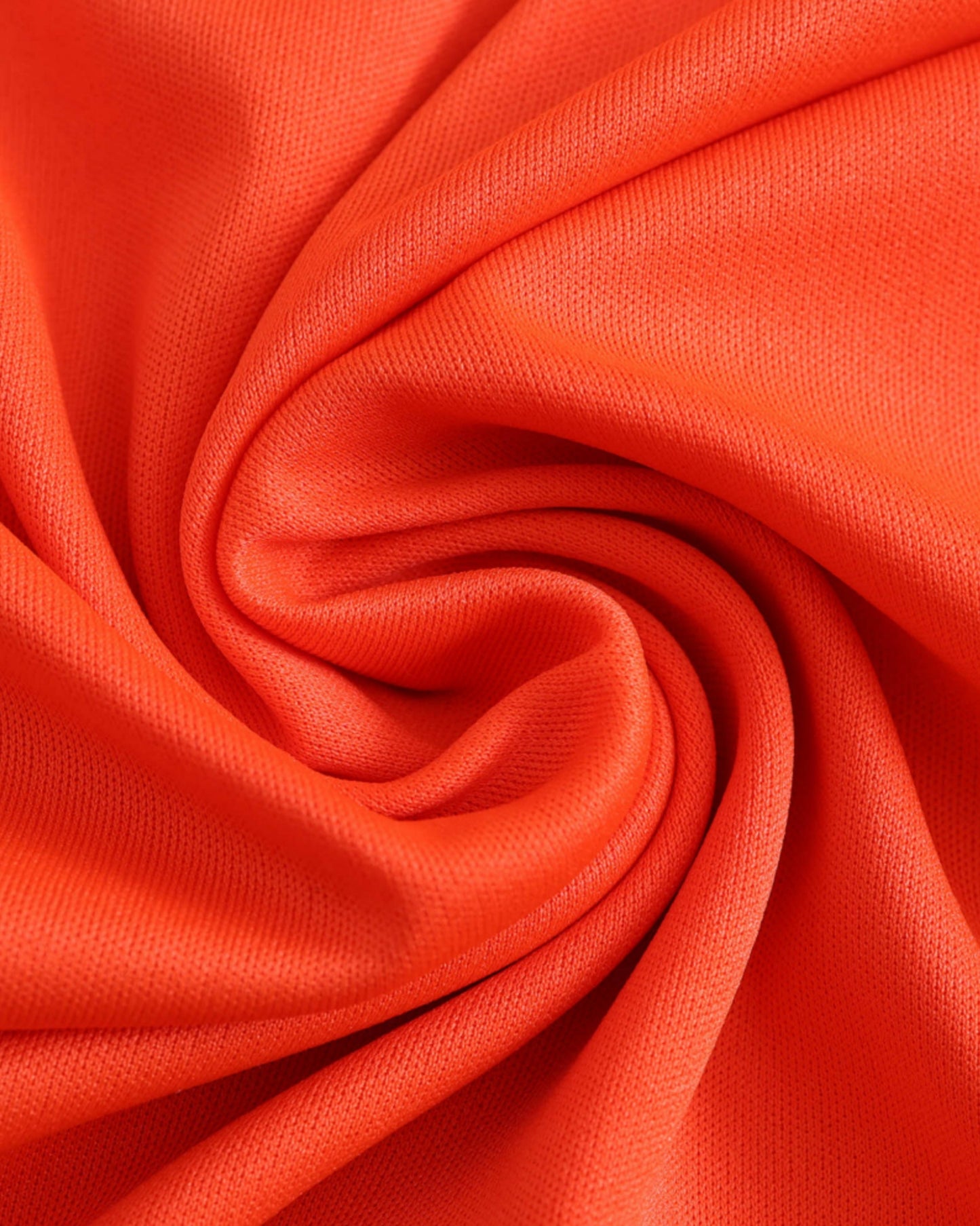 Orange fabric with a textured weave, folded into a swirl.