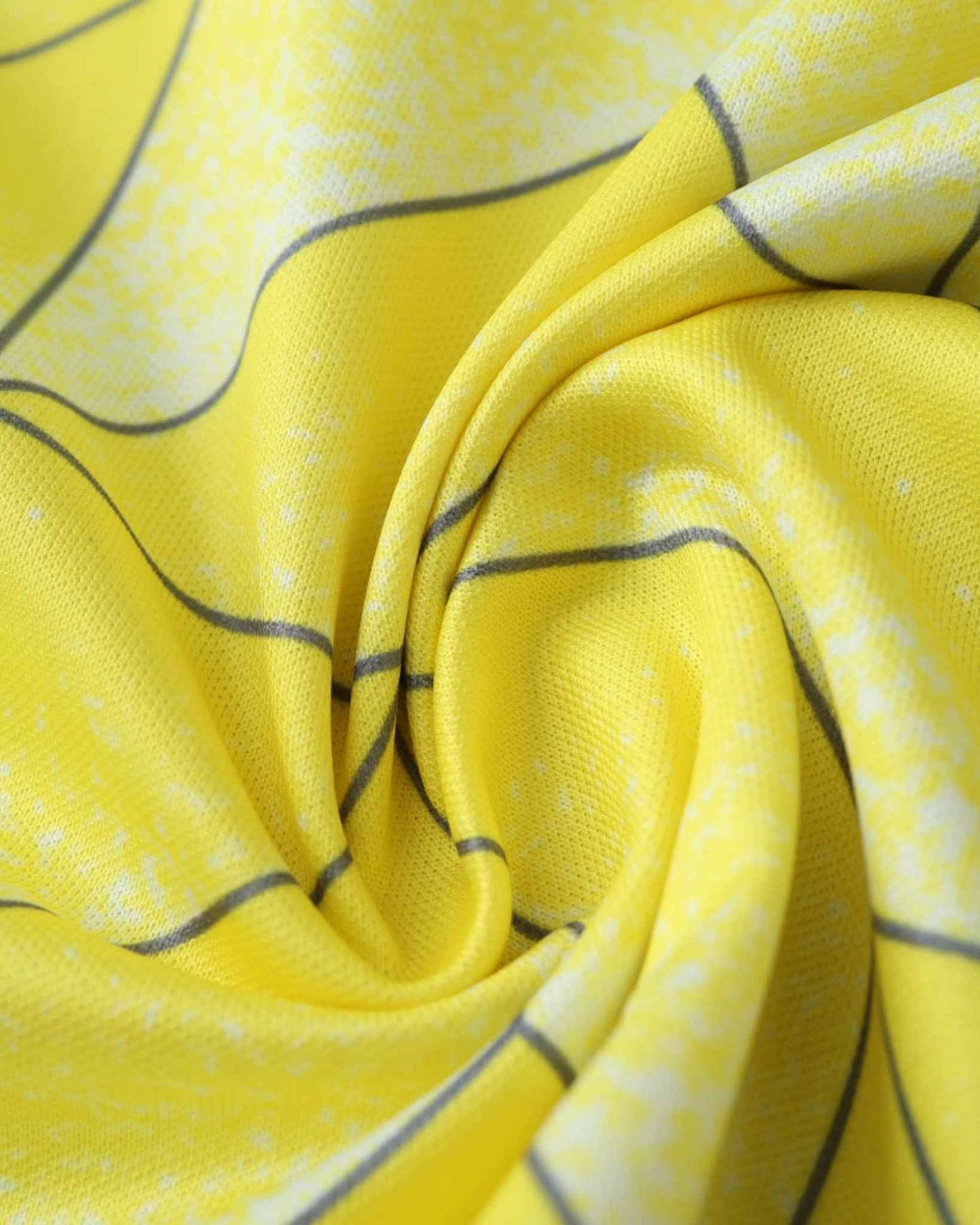 Close-up of a yellow football jersey with grey lines and a textured pattern.