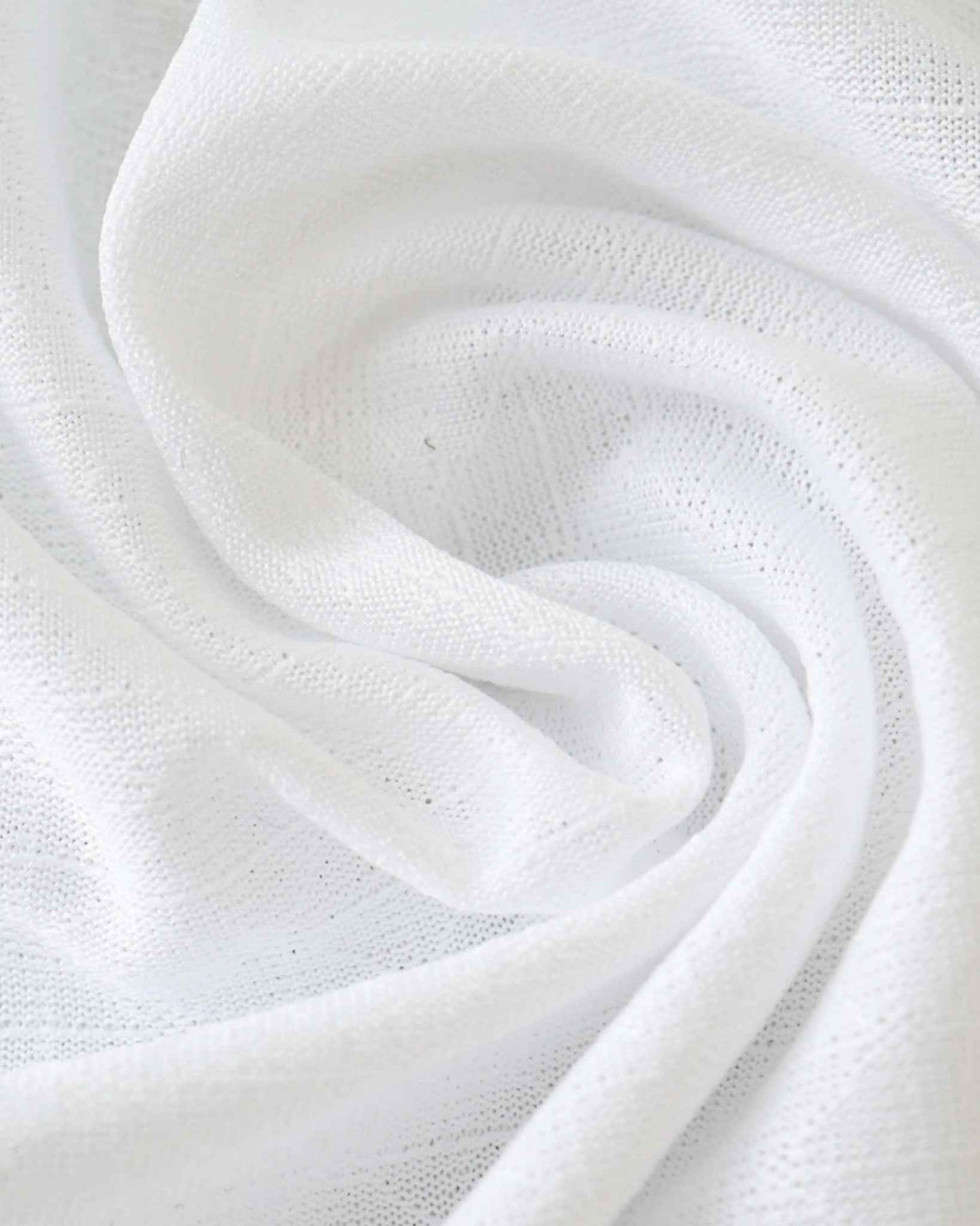 White textured fabric with soft folds.