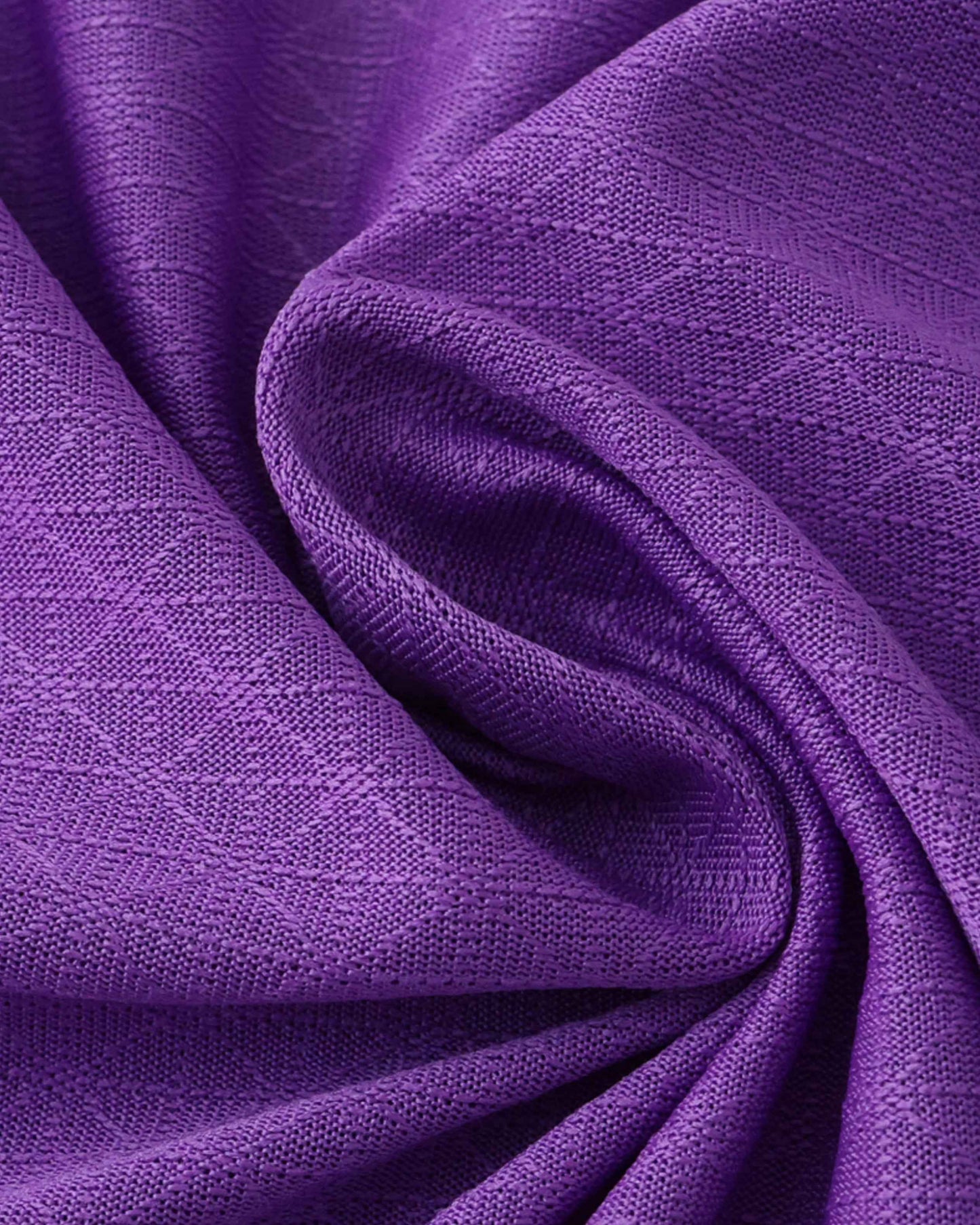 Purple fabric with a textured weave, draped in folds.