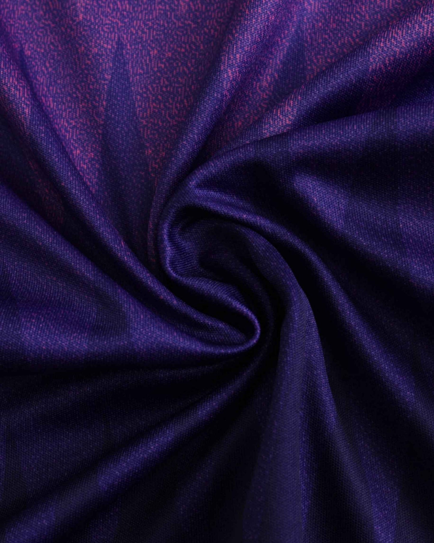 A close-up of a pink and purple patterned fabric with a swirl.