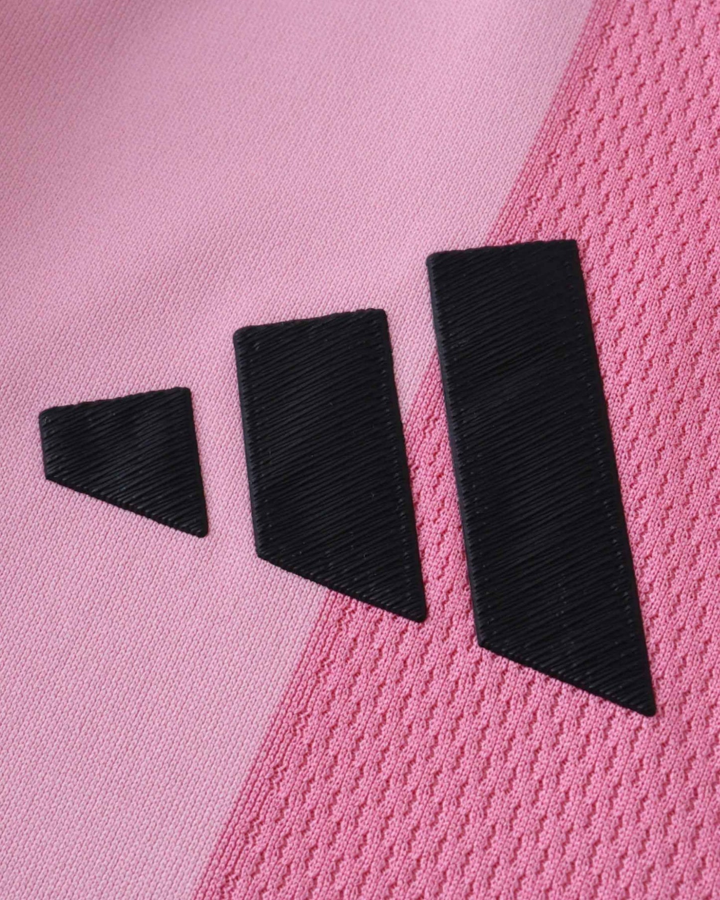 Pink Inter Miami CF jersey with black Adidas stripes.