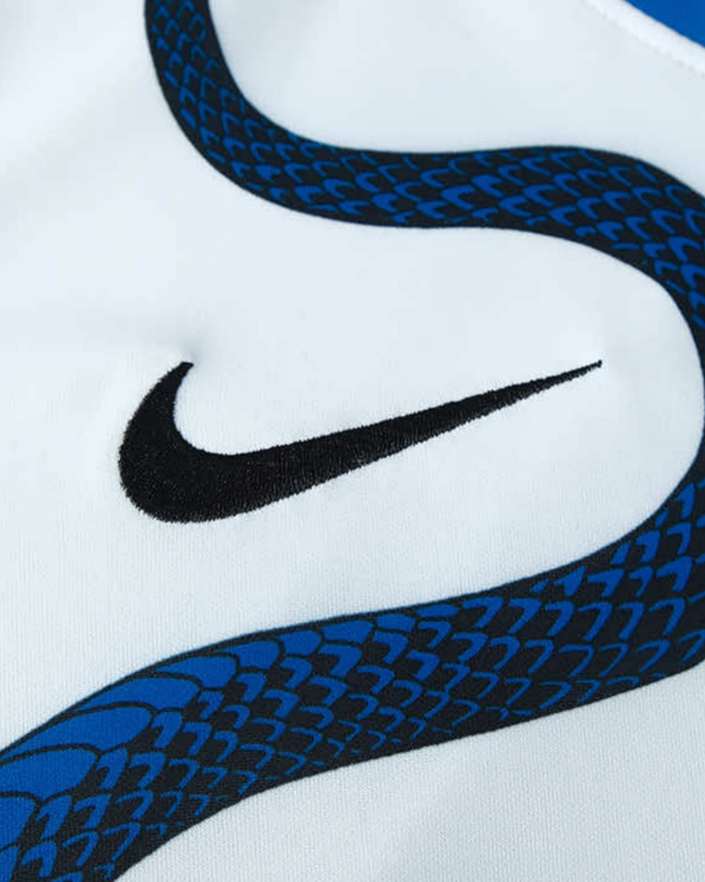 White Inter Milan 2021/22 away football jersey close-up with blue snake pattern and Nike swoosh