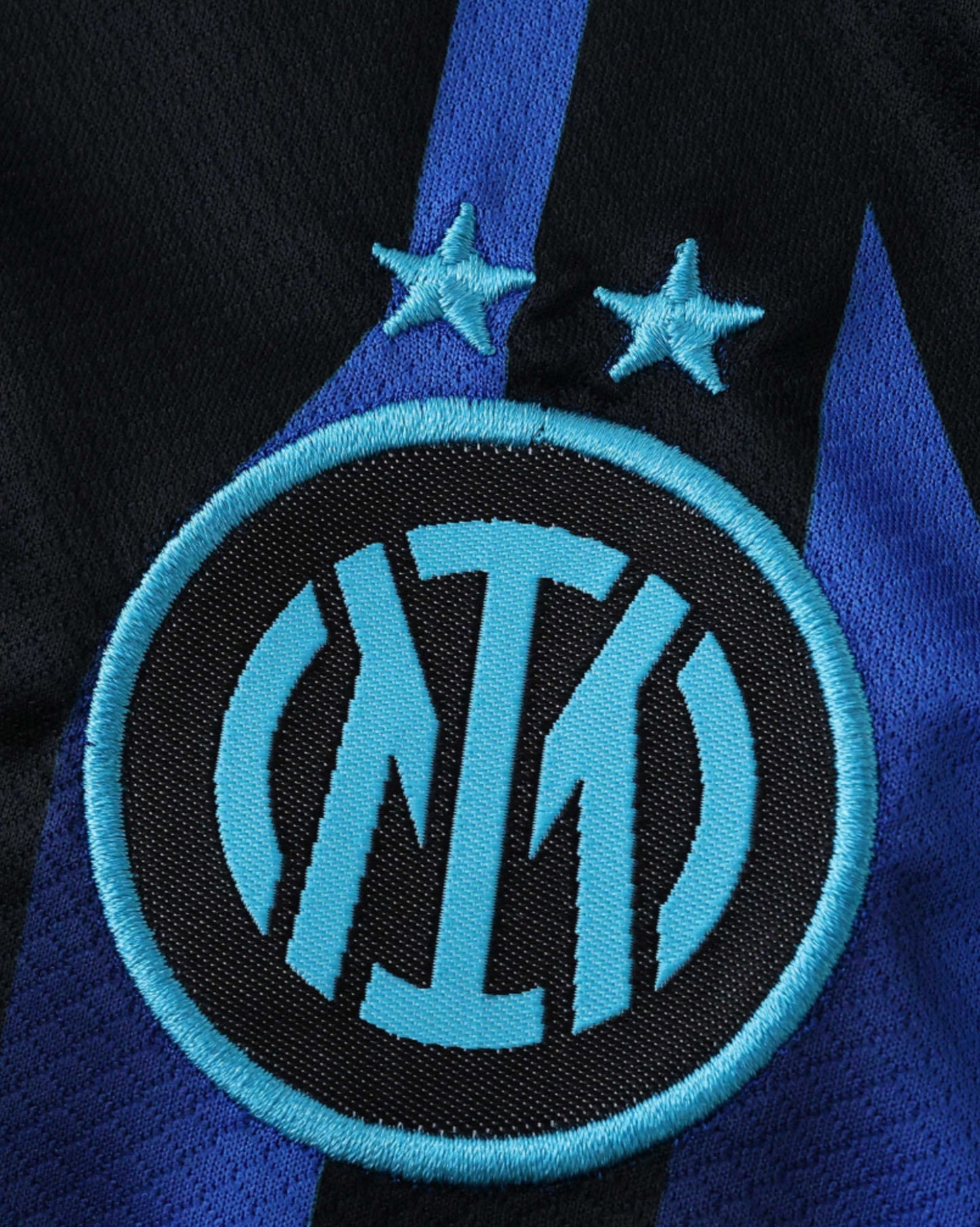 Inter Milan home football jersey 2025/26 close-up of two-star crest on striped fabric