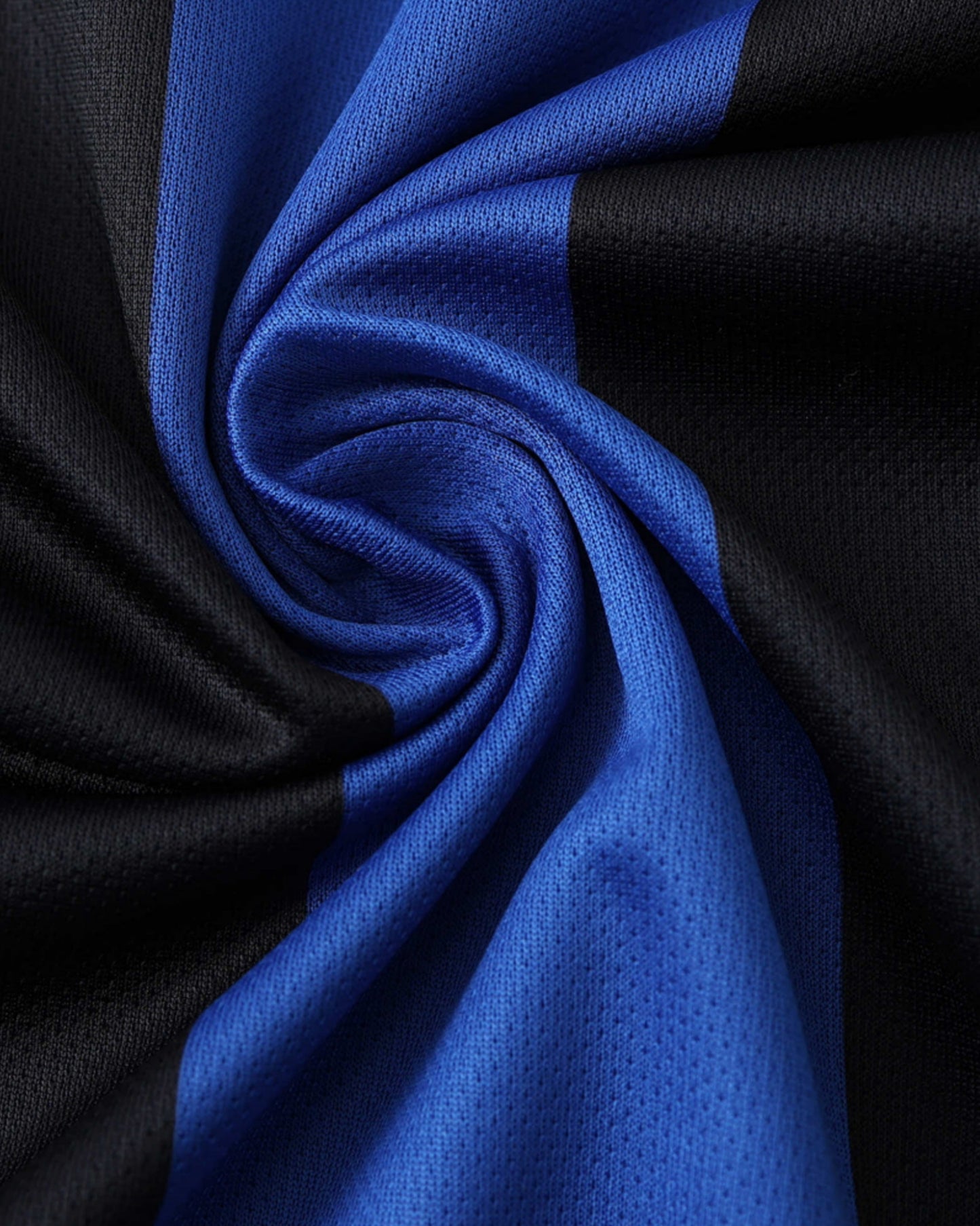 Close-up of the blue and black striped fabric of the Inter Milan 2001/02 retro home football jersey