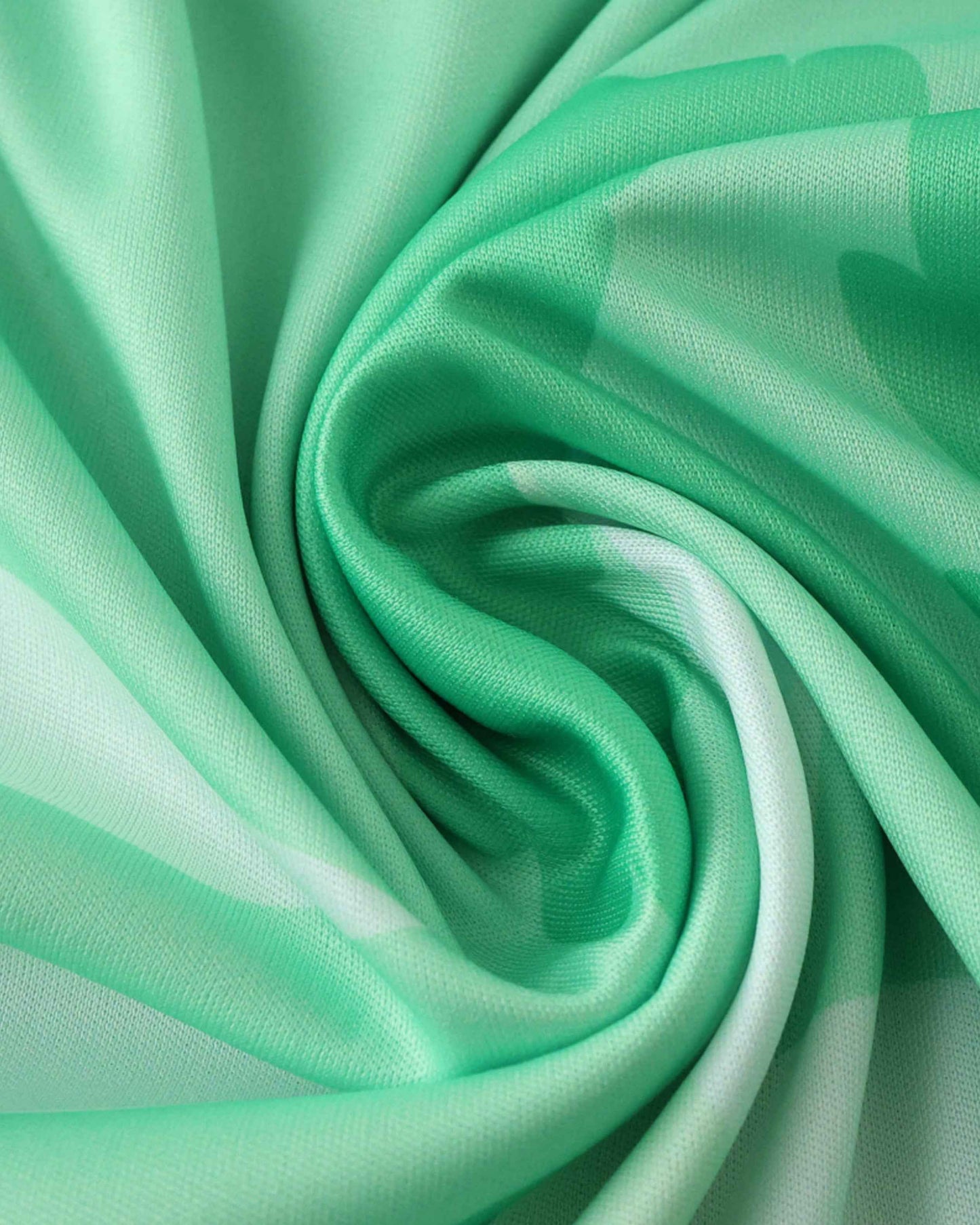 Green and white striped fabric with a swirled texture.