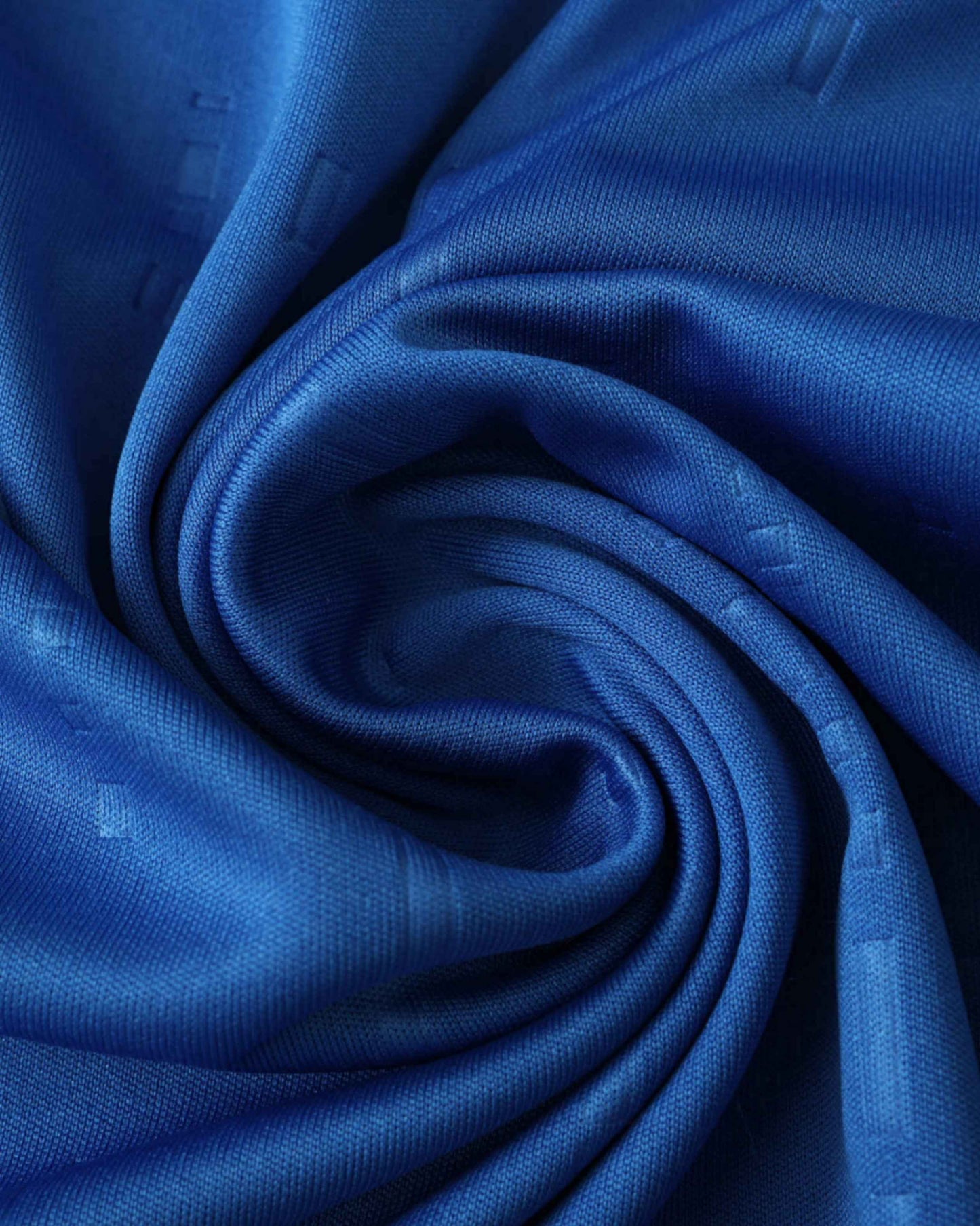 Blue textured fabric with a swirling pattern.