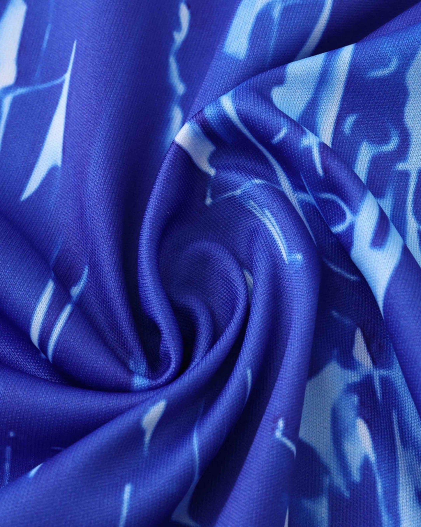 Blue fabric with a white abstract pattern, folded.