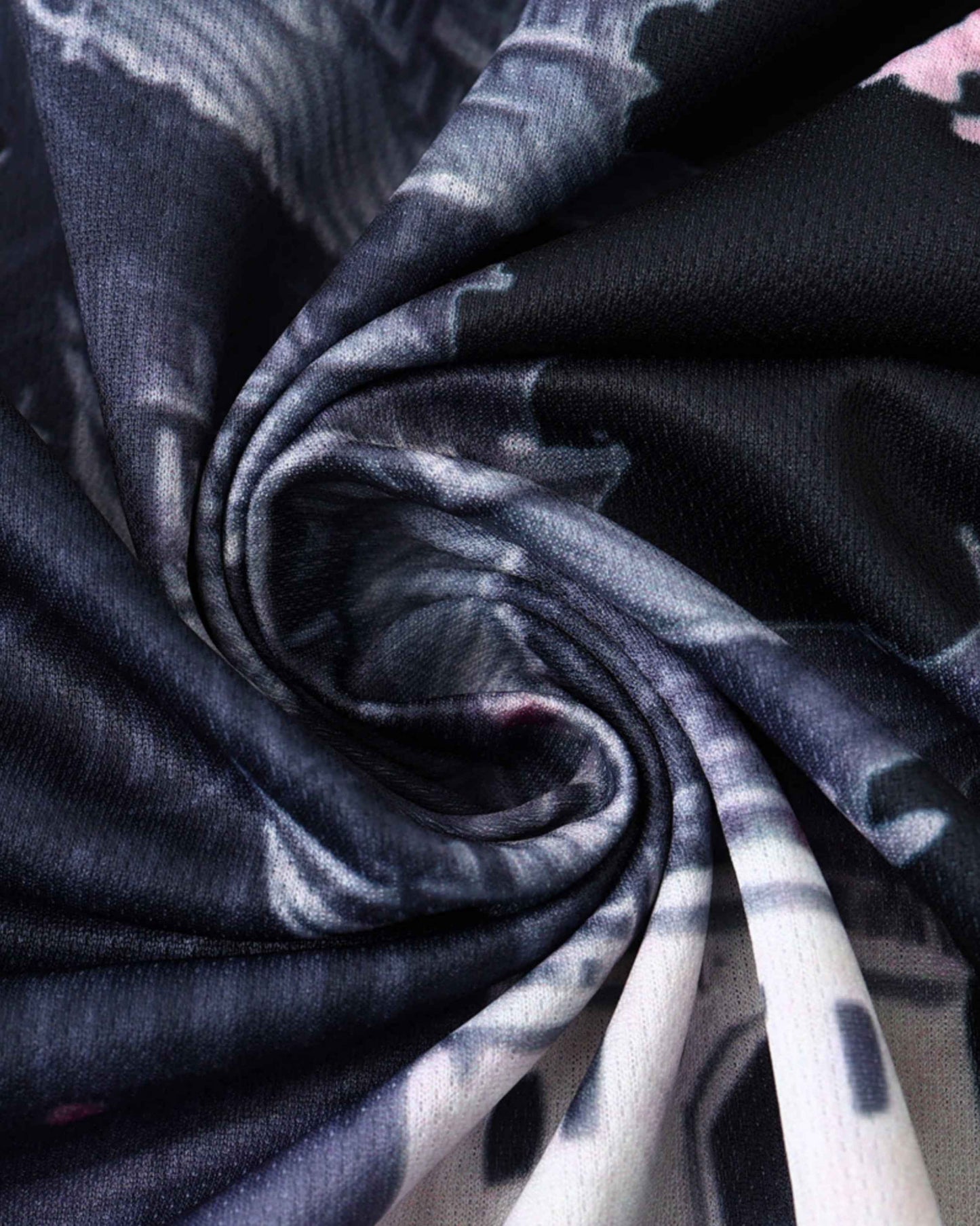 A close-up of black fabric with a swirling sakura dragon print.
