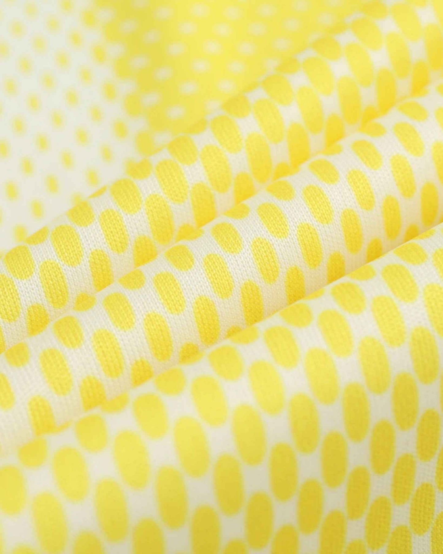 Yellow and white polka dot fabric