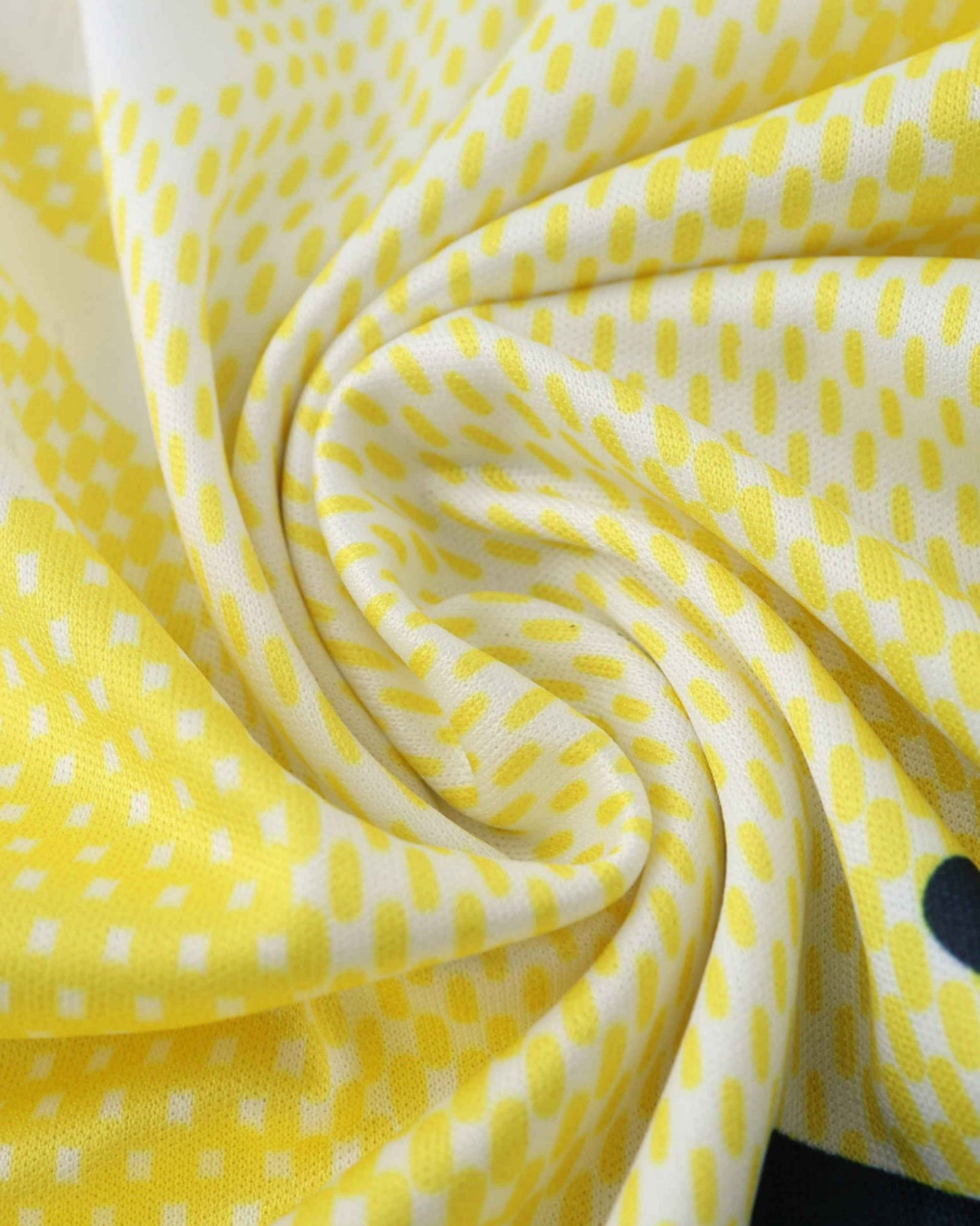 White and yellow polka dot fabric with a black trim.