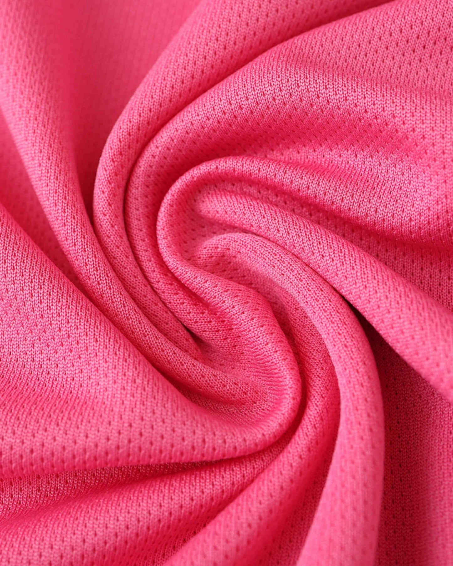 Close-up of a pink, textured fabric with small perforations.