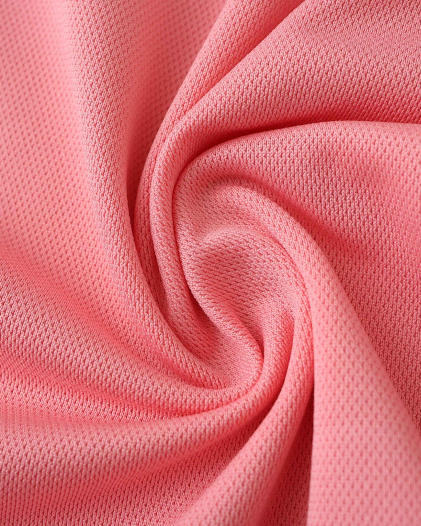 Pink textured fabric with a subtle diamond pattern, folded into soft pleats.
