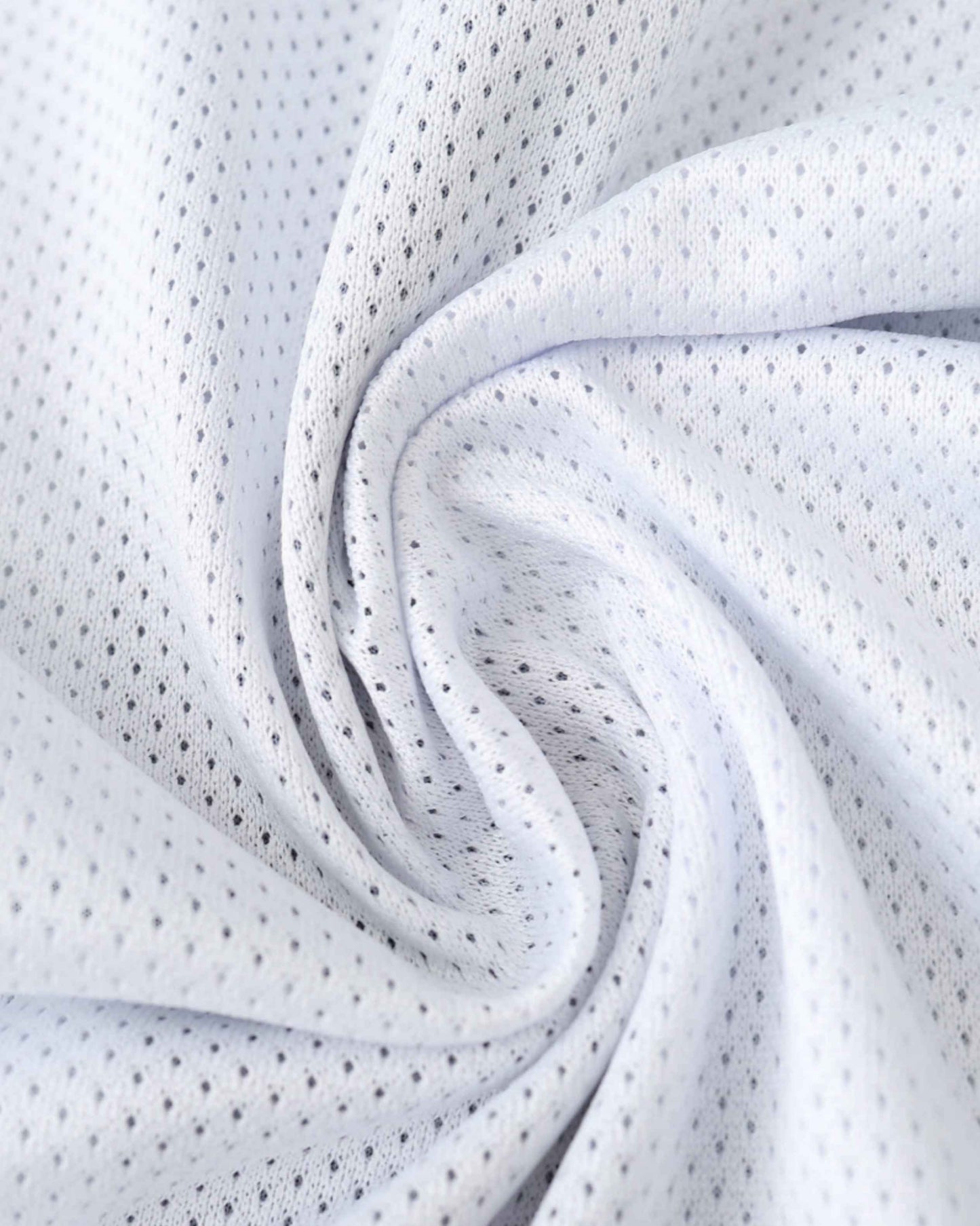 White and black mesh fabric with small perforations, draped in folds.