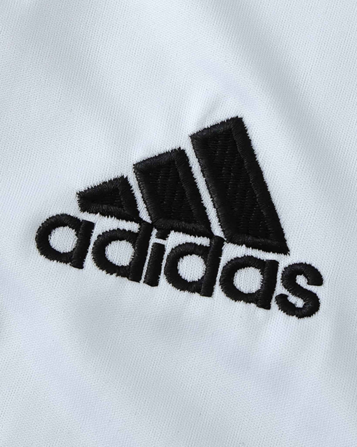 Black Adidas logo embroidered on a white Juventus retro football jersey.