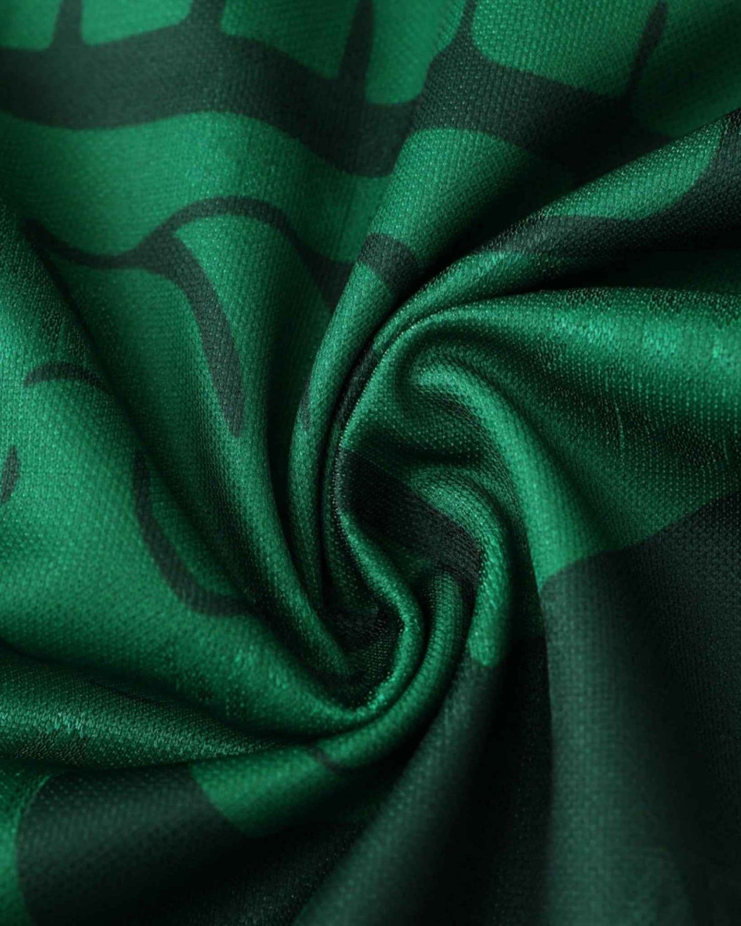 Green and black patterned fabric of a vintage Mexico football jersey.
