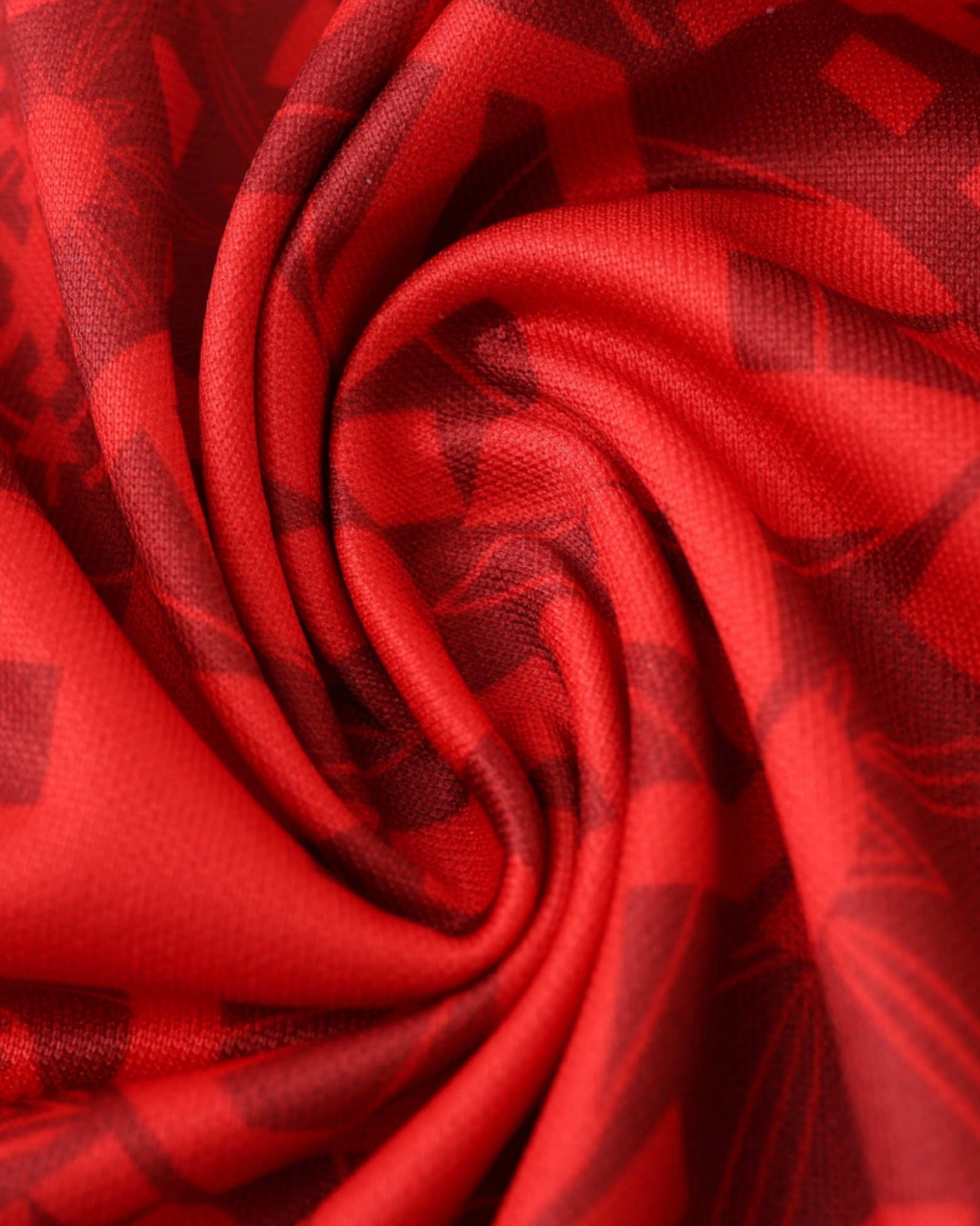 Close-up of red Portugal x The Siu football jersey fabric with azulejo geometric pattern