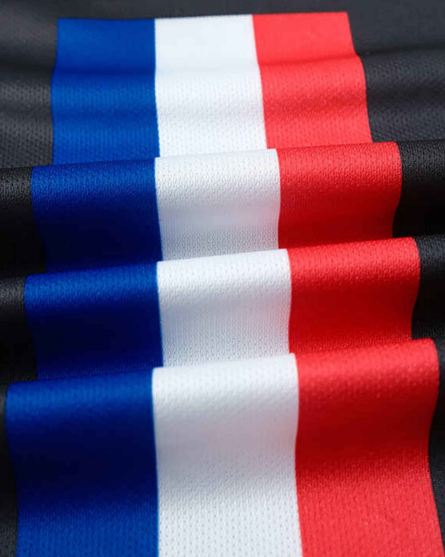 A close-up of a fabric with vertical stripes of blue, white, and red.