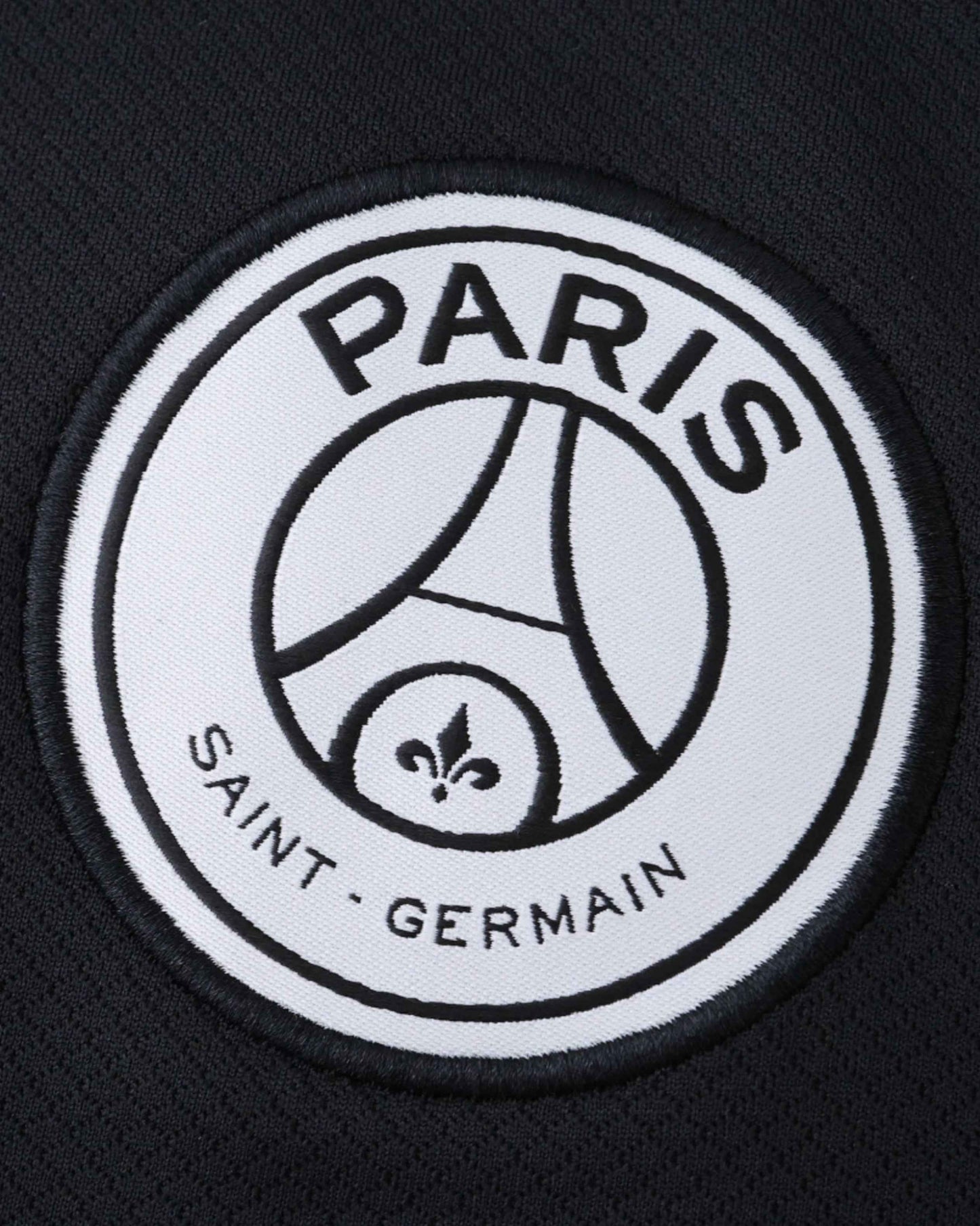Black football jersey with the Paris Saint-Germain crest.
