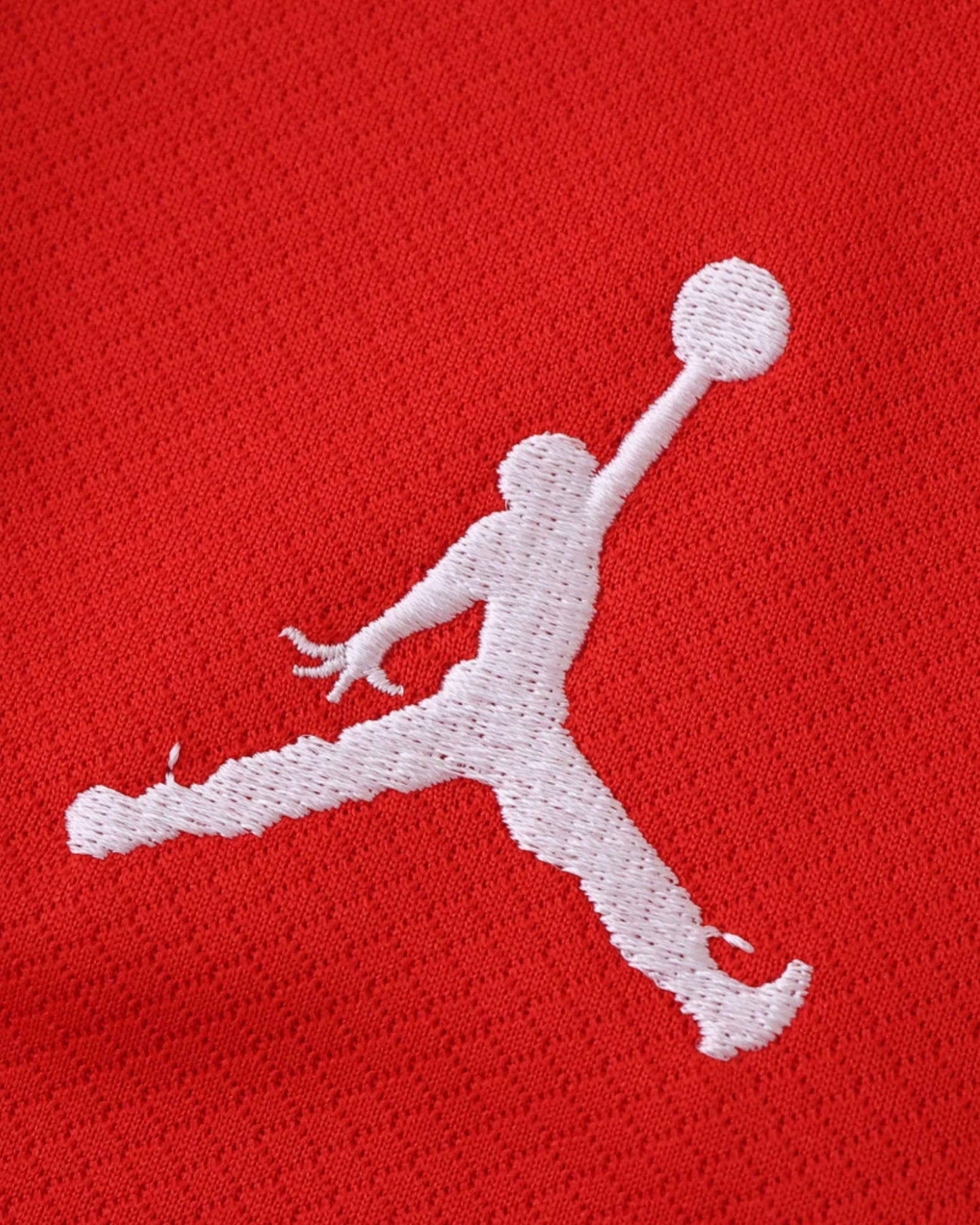 Red football jersey with white Jumpman logo.