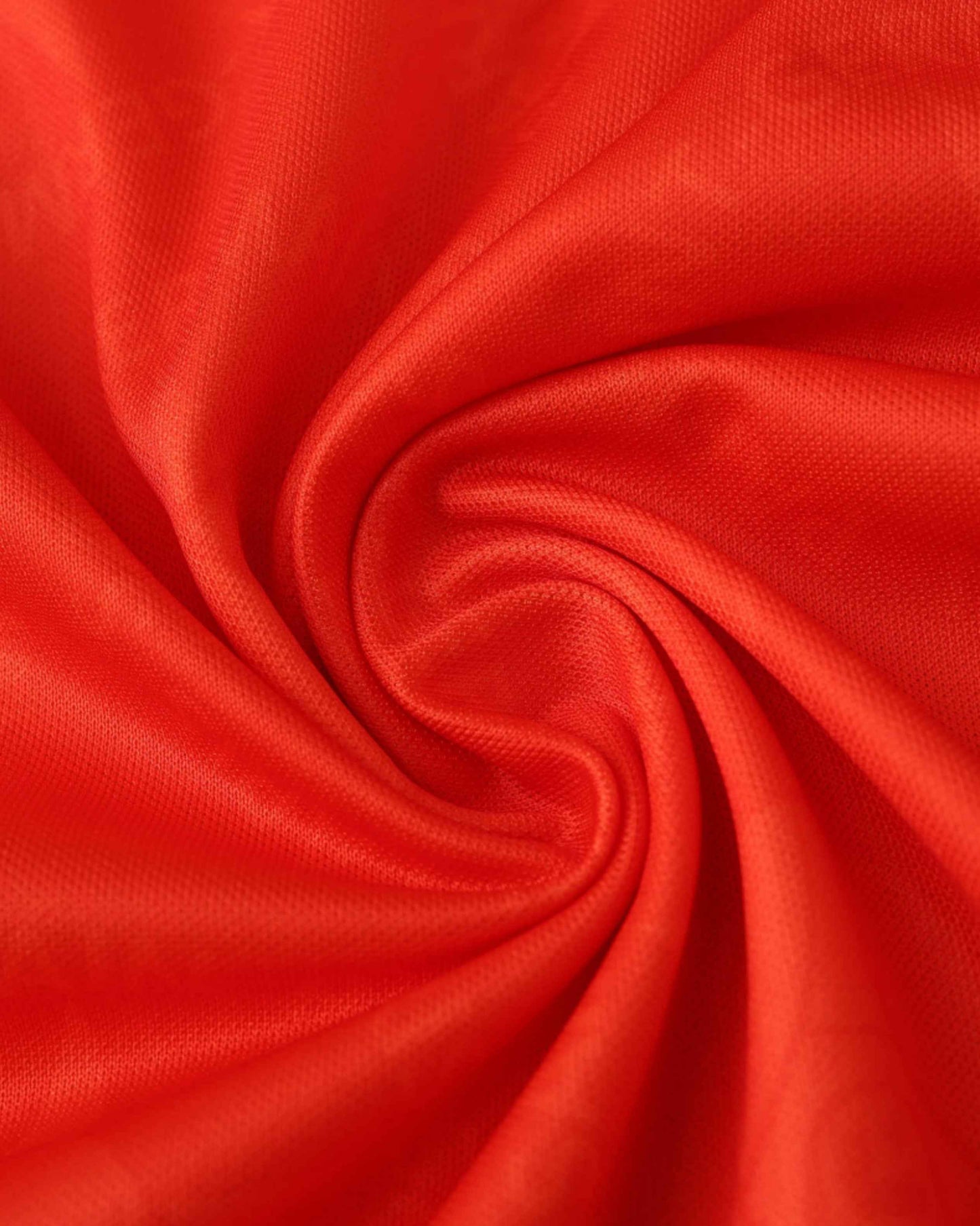 Red fabric with a swirling pattern.