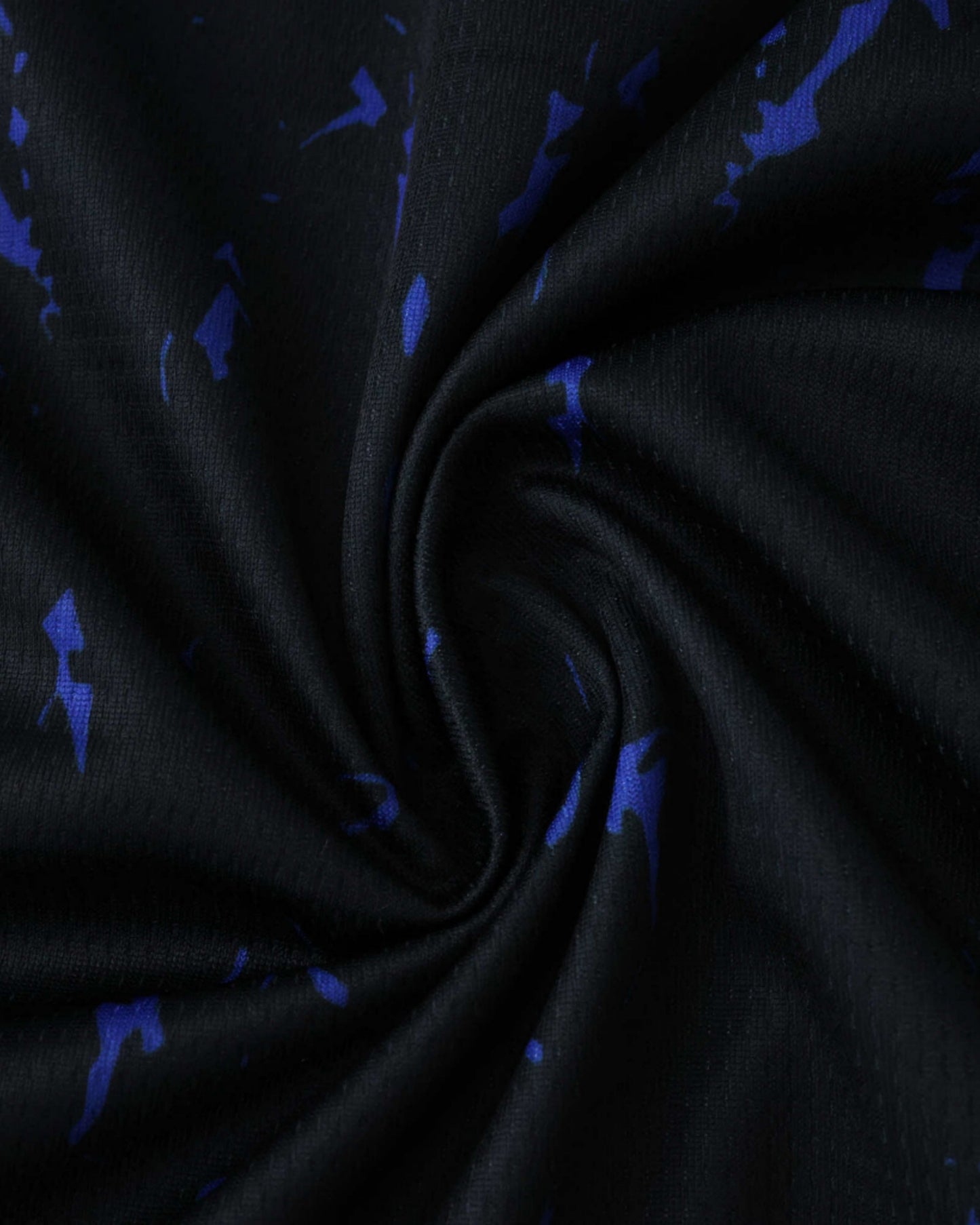 PSG x The Parisians premium football jersey close-up of black fabric with blue splatter pattern