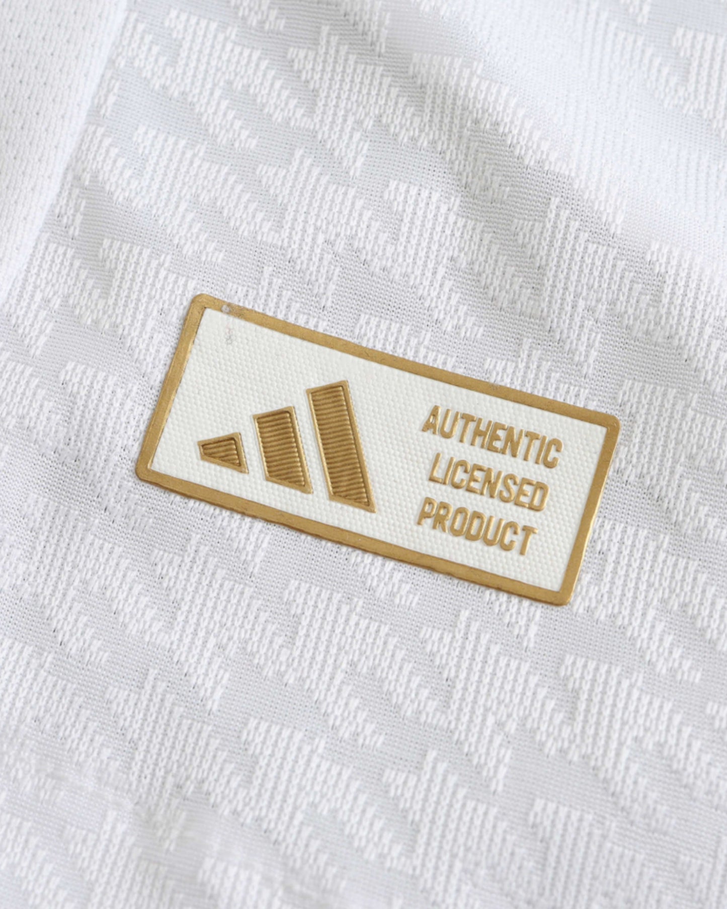 White Real Madrid home football jersey 2024/25 with gold Adidas authentic detailing