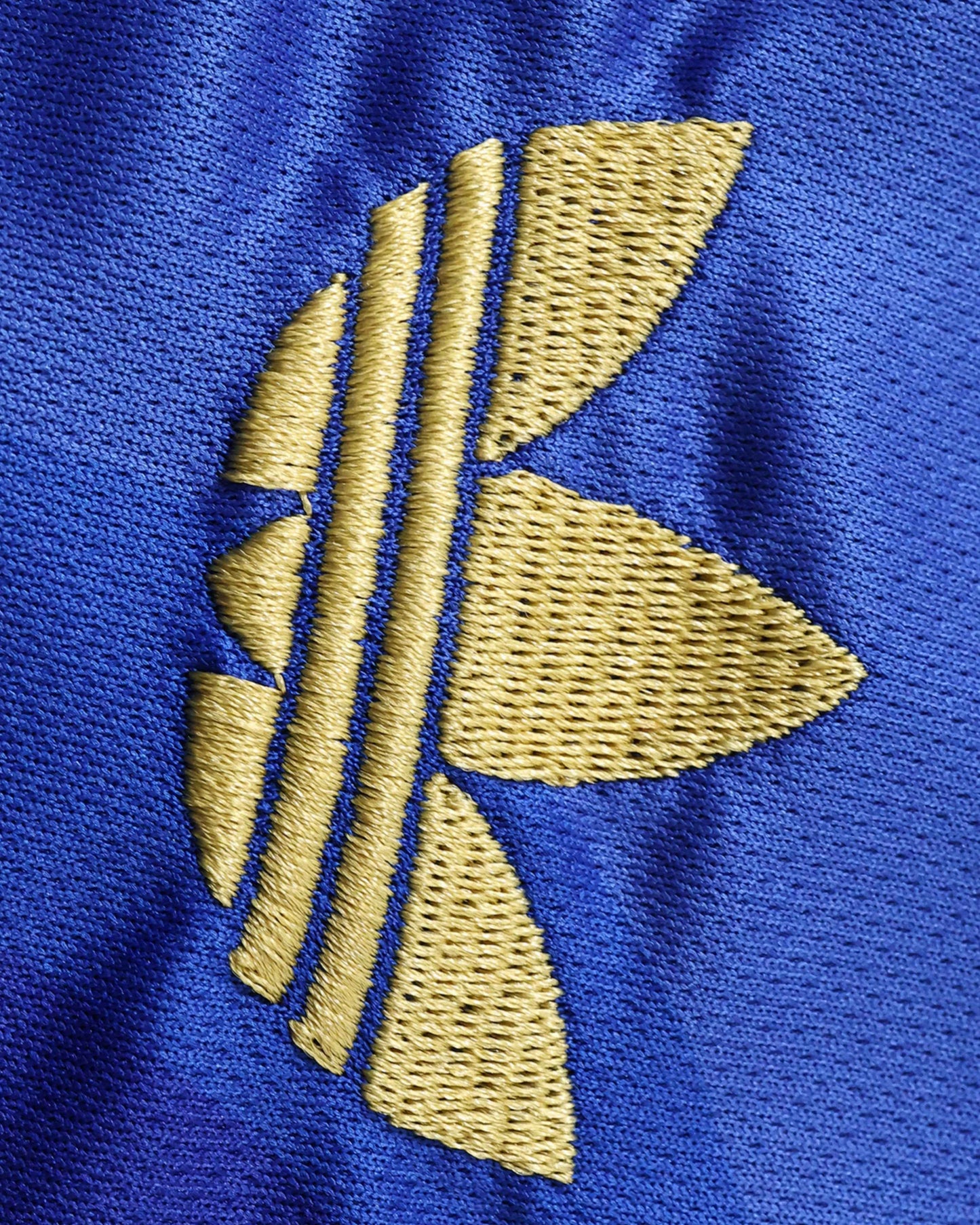Real Madrid Chinese Knot kids football jersey detail of blue shorts with gold stripes and crest