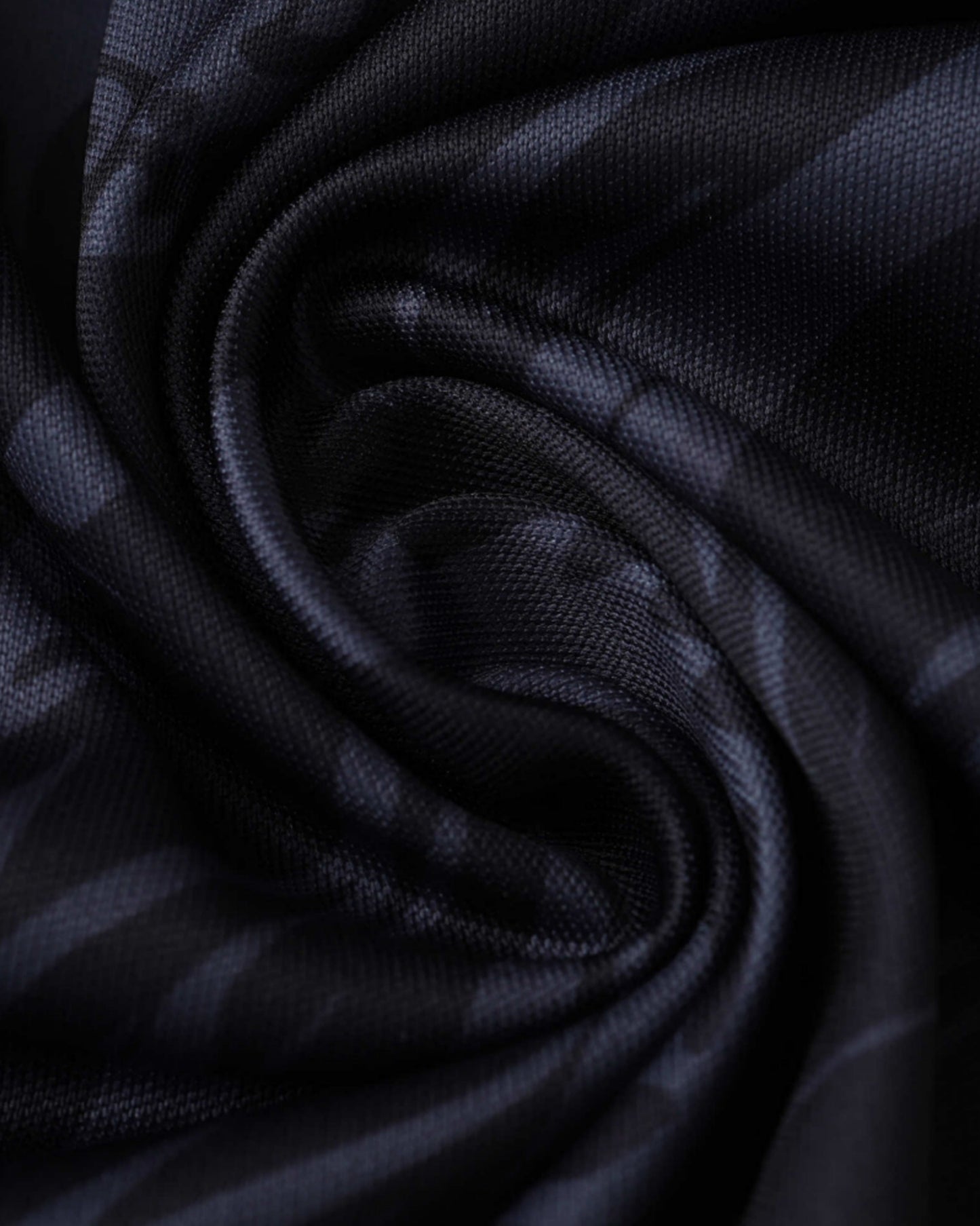 Close-up of black Real Madrid Devil's Eye football jersey dragon print fabric